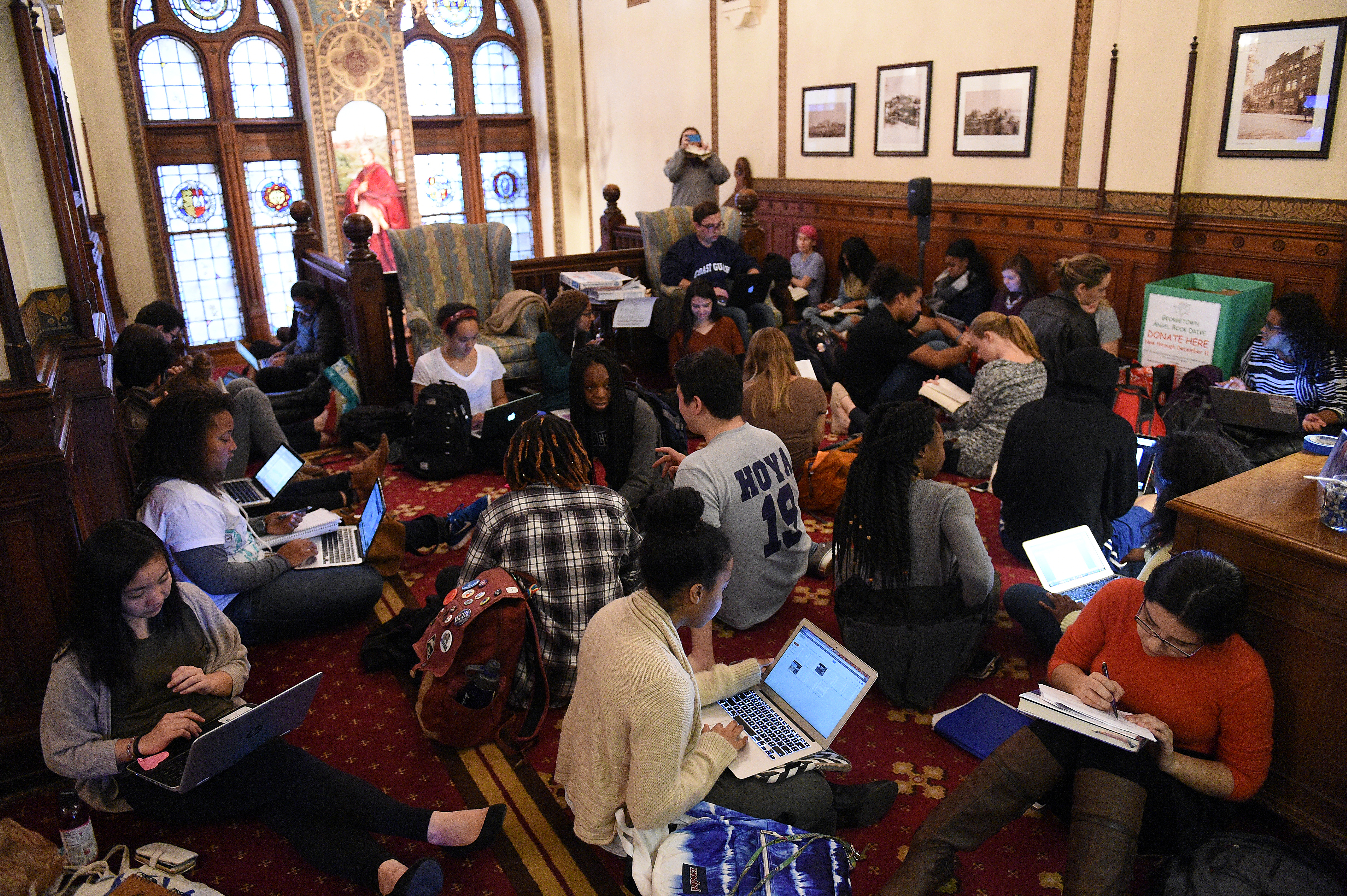 Around 30 students sit in in front of the office of John J. DeGioia, president of Georgetown University in Washington D.C. on Nov. 13, 2015. The sit in was in solidarity with other student protests throughout the country addressing racial discrimination 