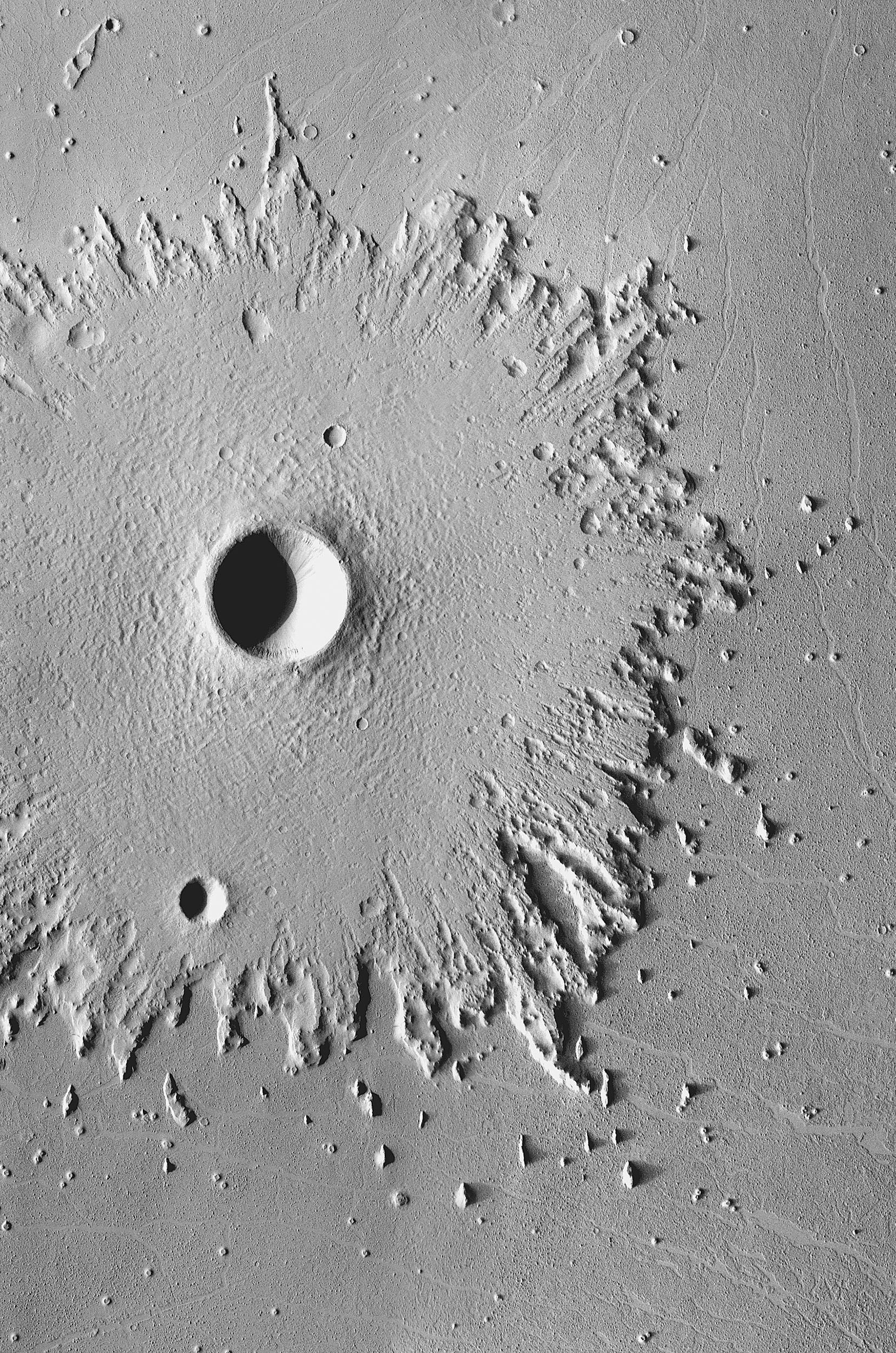 Radical Erosion: The wide, circular blanket of ejected debris surrounding this crater has become greatly eroded by the wind, which has stripped its surface features. This images was acquired between May 2003 and April 2006 by the Thermal Emission Imaging