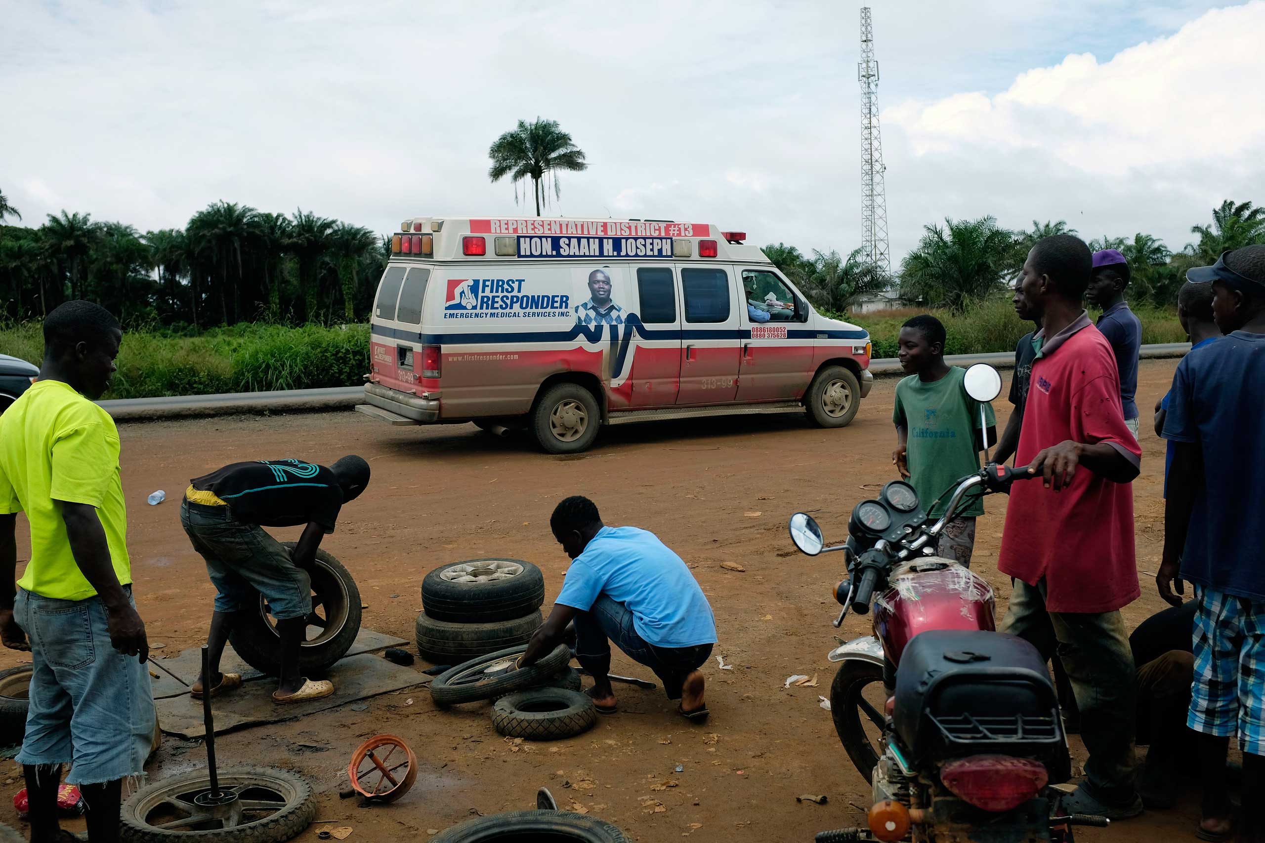 A District 13 ambulance stops on the side of the road looking for suspected Ebola sufferers in Monrovia, Liberia, Sept. 30, 2014.