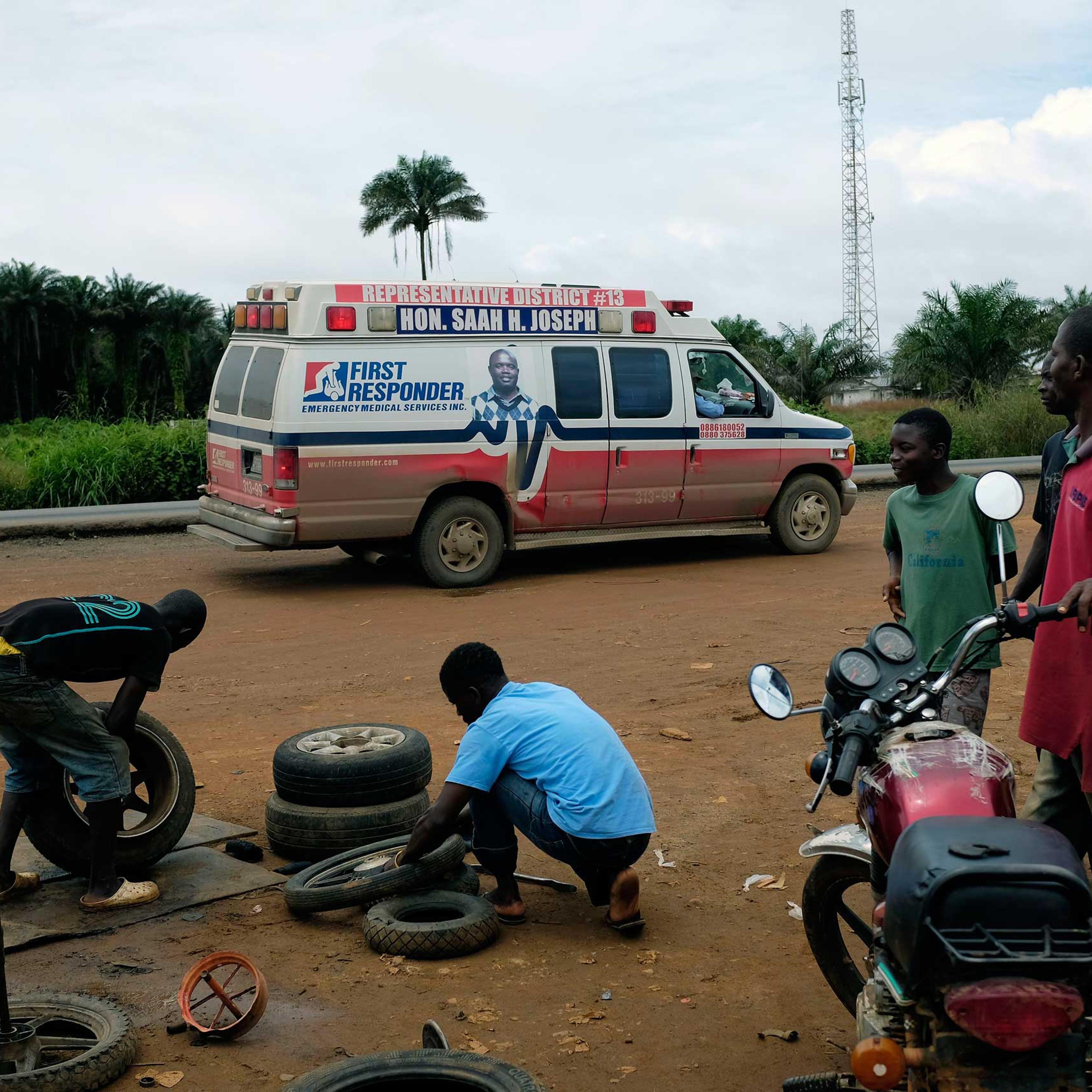 A District 13 ambulance stops on the side of the road looking for suspected Ebola sufferers in Monrovia, Liberia, Sept. 30, 2014.
