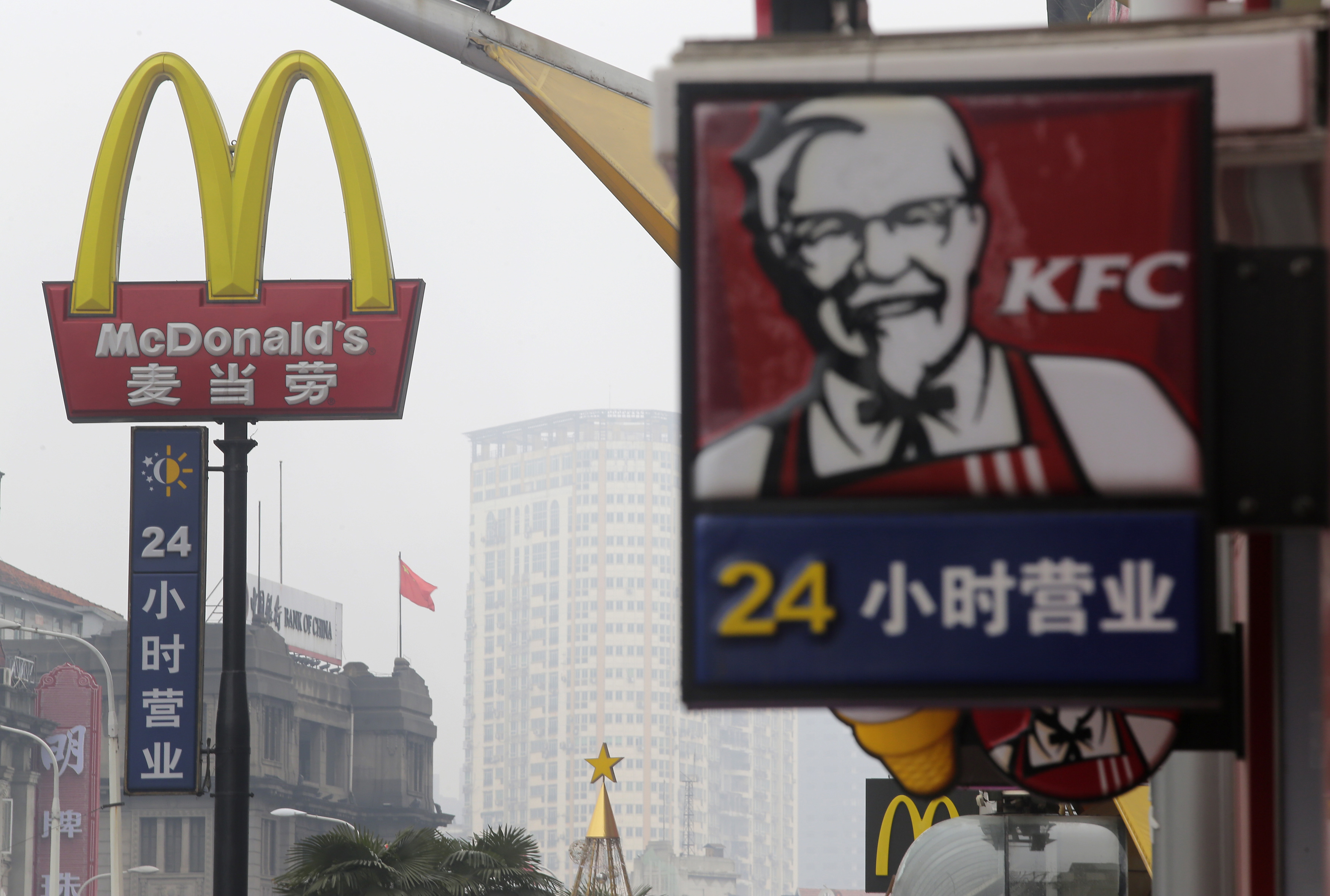 A McDonald's logo is seen next to a logo of KFC in Wuhan, Hubei province