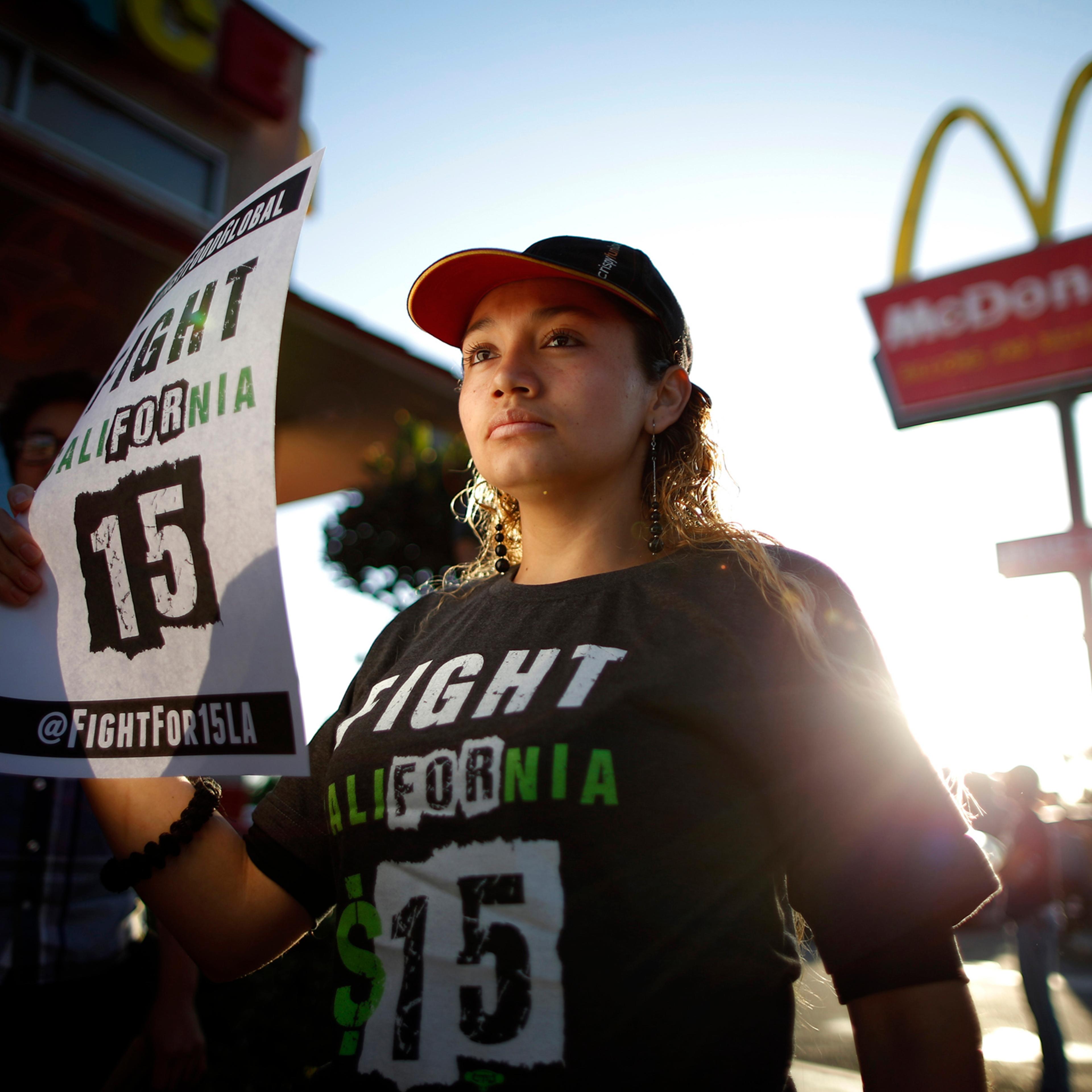 Demonstrators take part in a protest to demand higher wages for fast-food workers outside McDonald's in Los Angeles