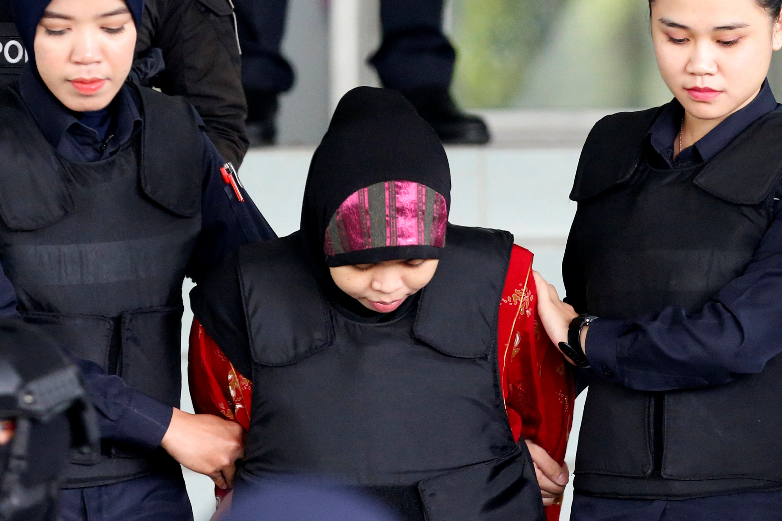 Indonesian Siti Aisyah is escorted as she leaves the Shah Alam High Court on the outskirts of Kuala Lumpur
