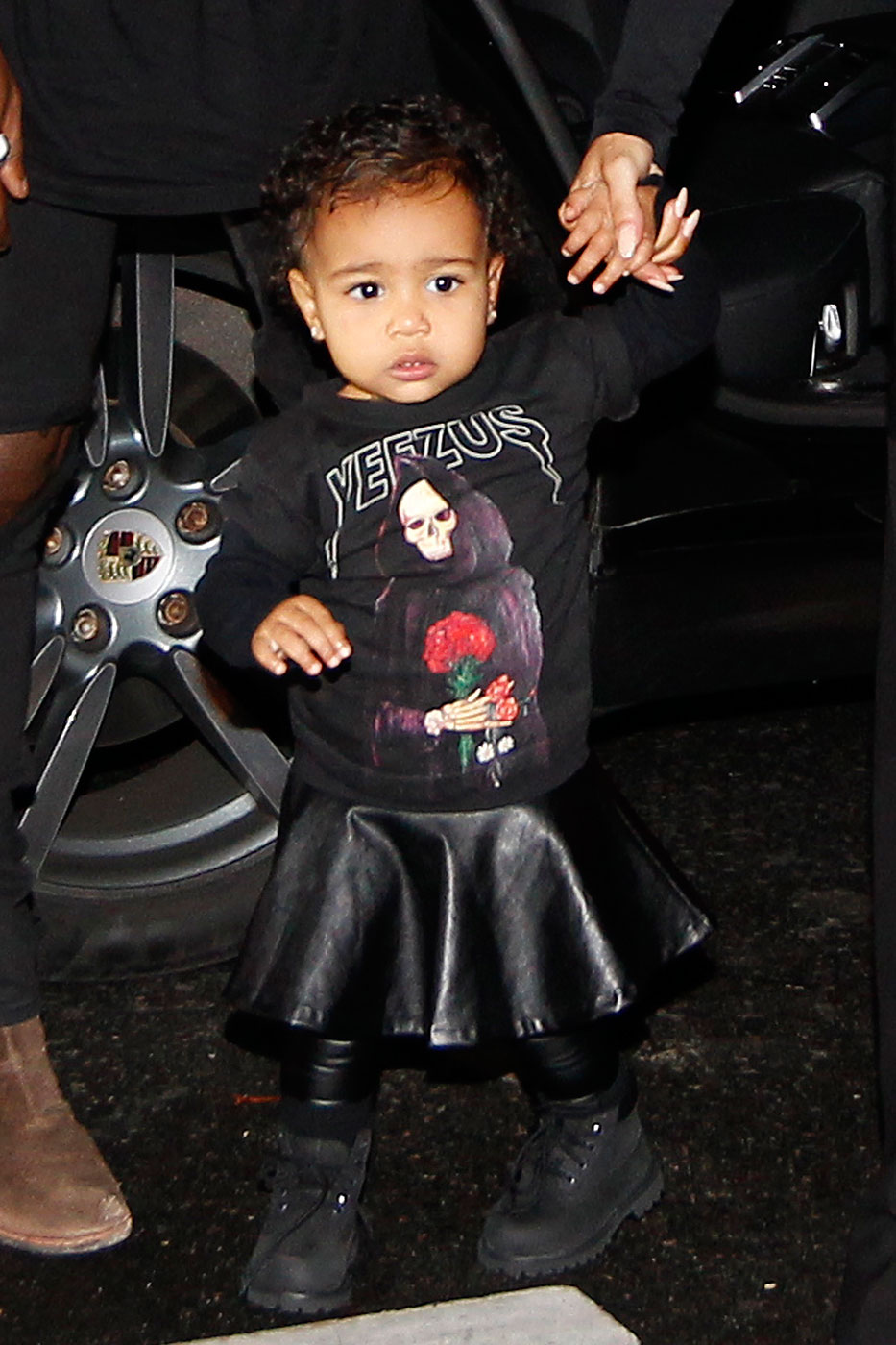 Kanye West, Kim Kardashian and their daughter North West walk to the Balenciaga Womenswear Spring/Summer 2015