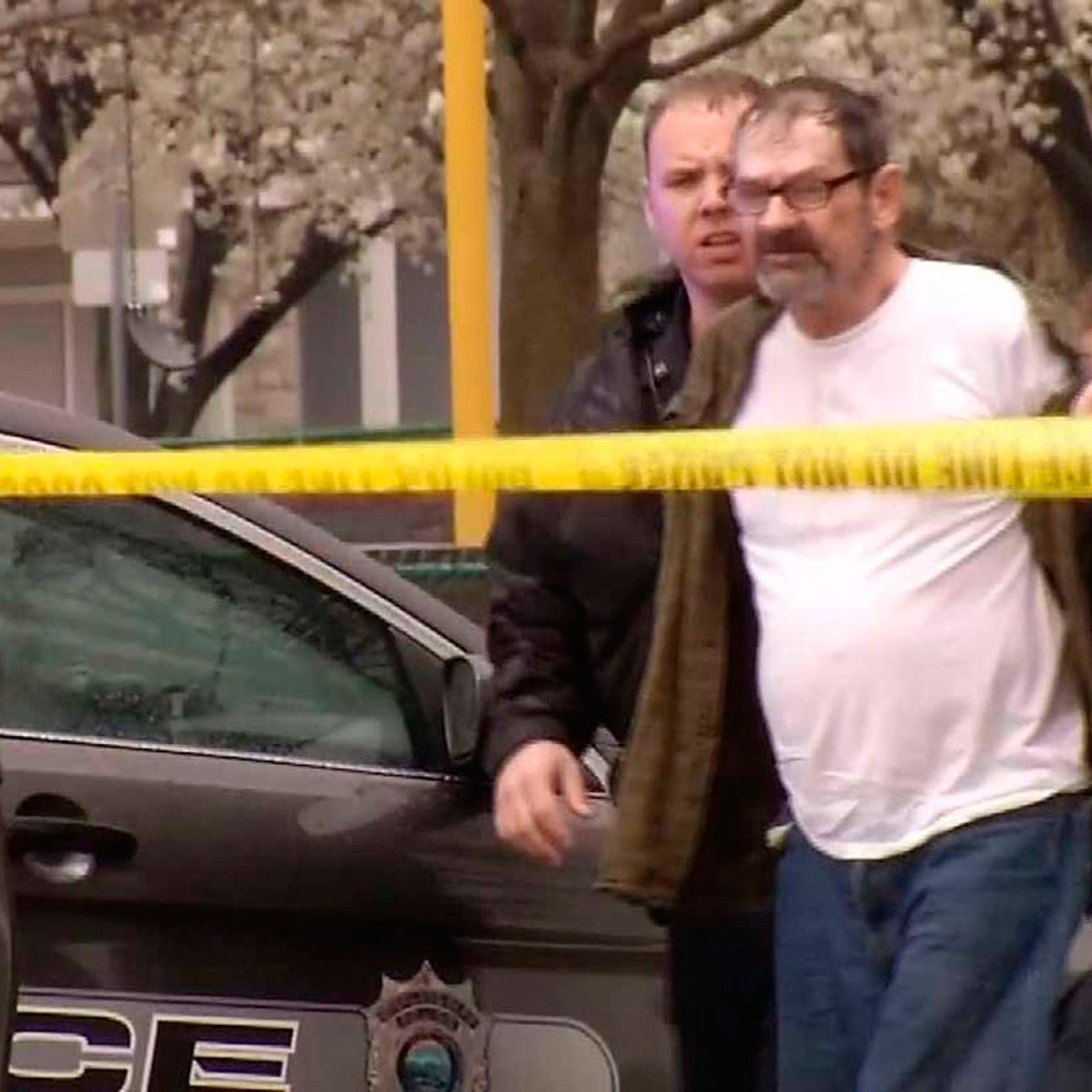 Frazier Glenn Cross, 73, of Aurora, Missouri, is led to a police car after his arrest following shooting incidents which killed three people at two Jewish centers on Sunday in Overland Park, south of Kansas City, Kansas in a still image from video April