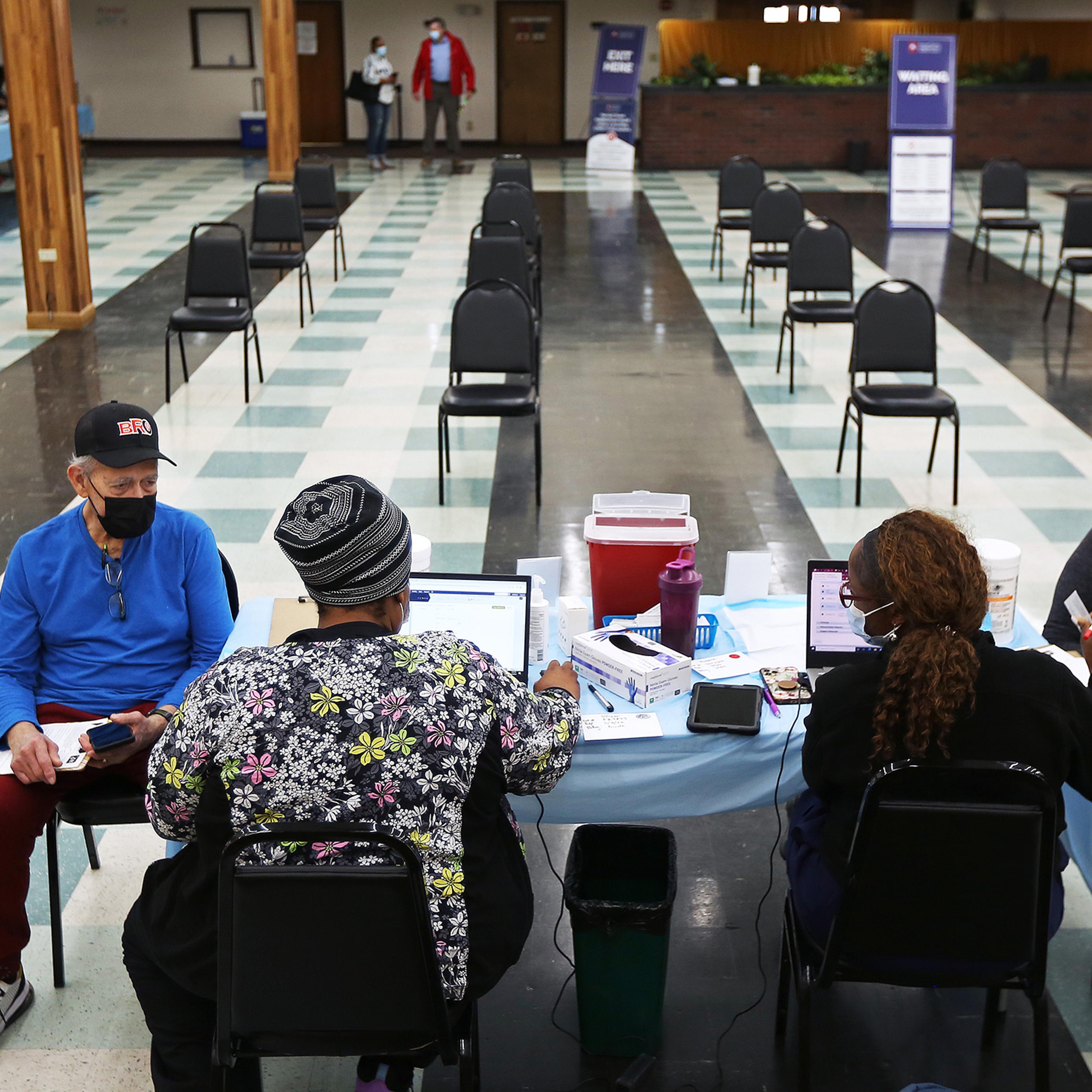 Patients wait to receive their second boosters at a COVID-19 testing and vaccination site at the Harvard Street Neighborhood Health Center in Boston on April 5, 2022.