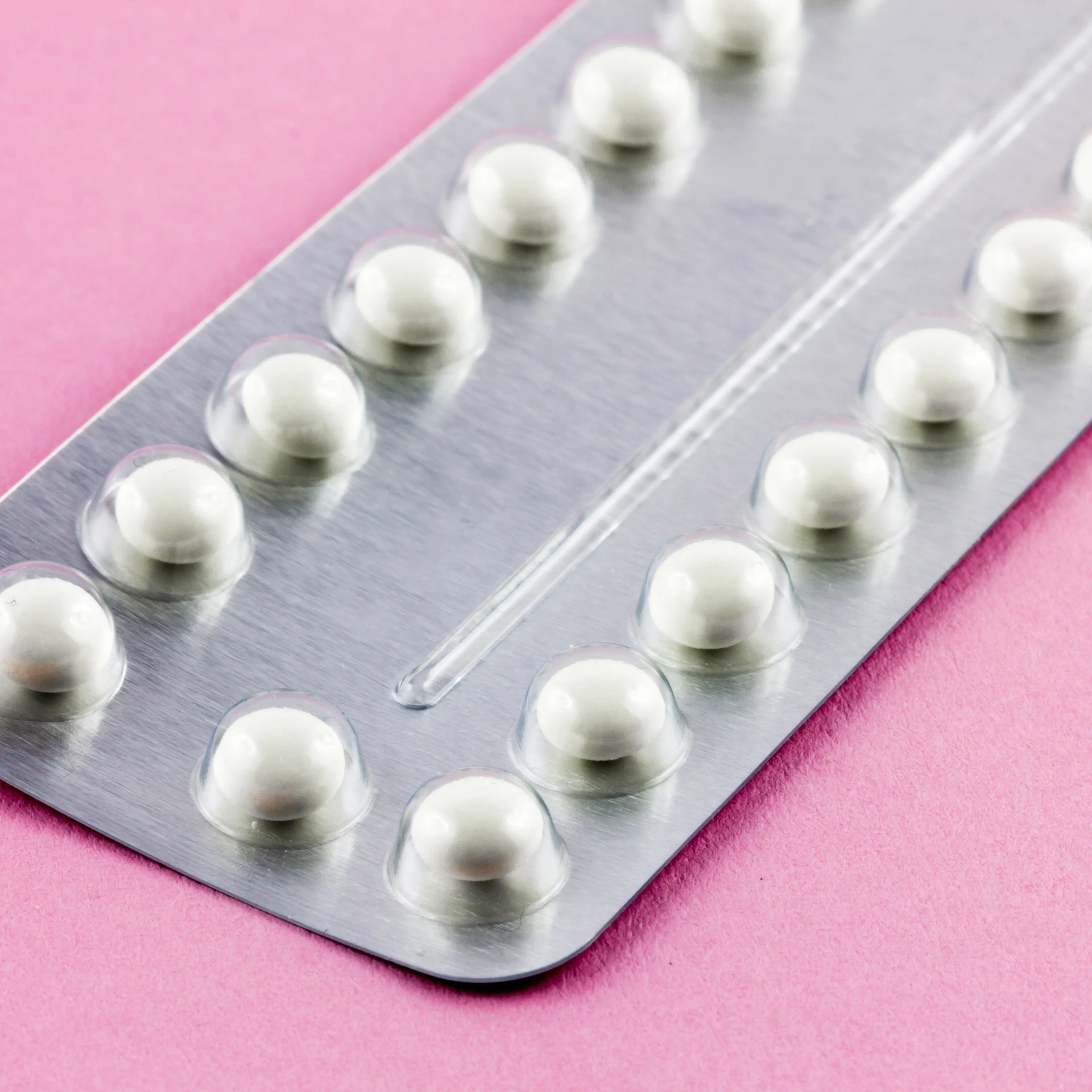 Birth control Pills on a pink background