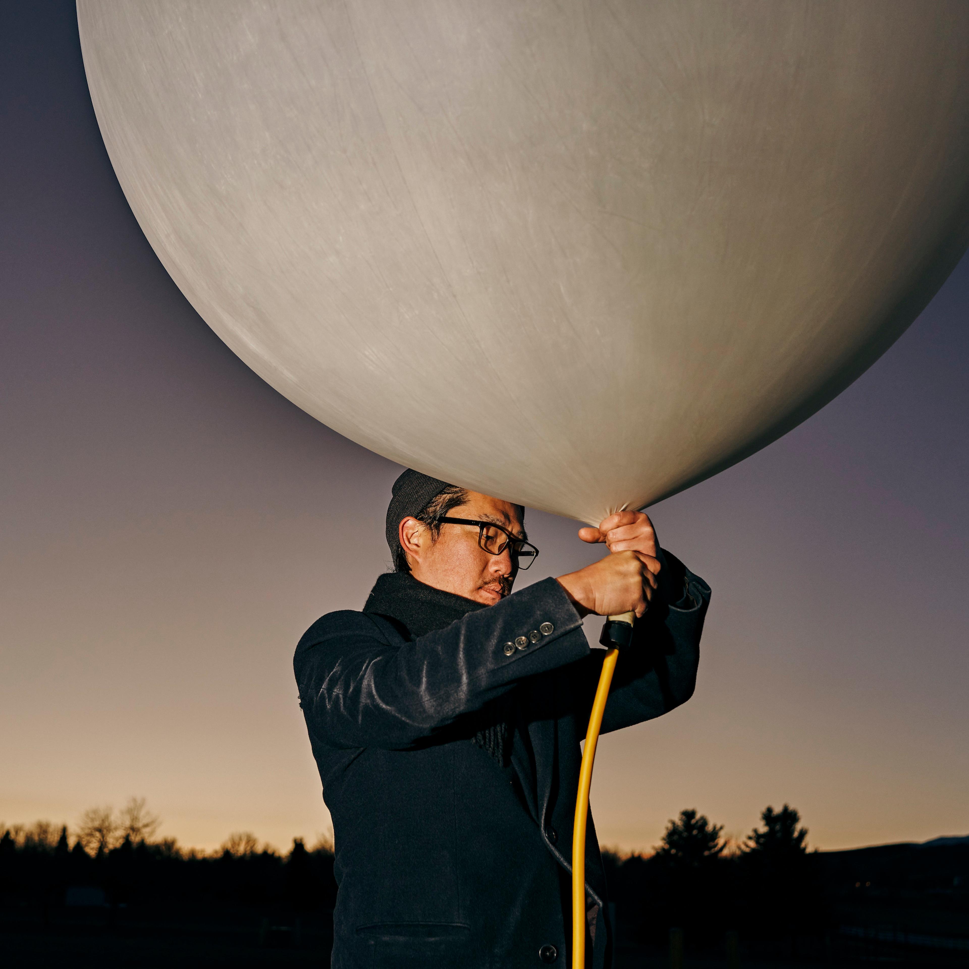 Co-founder Andrew Song of solar geoengineering startup Make Sunsets holds a weather balloon filled with helium, air and sulfur dioxide at a park in Reno, Nevada, United States on February 12, 2023.