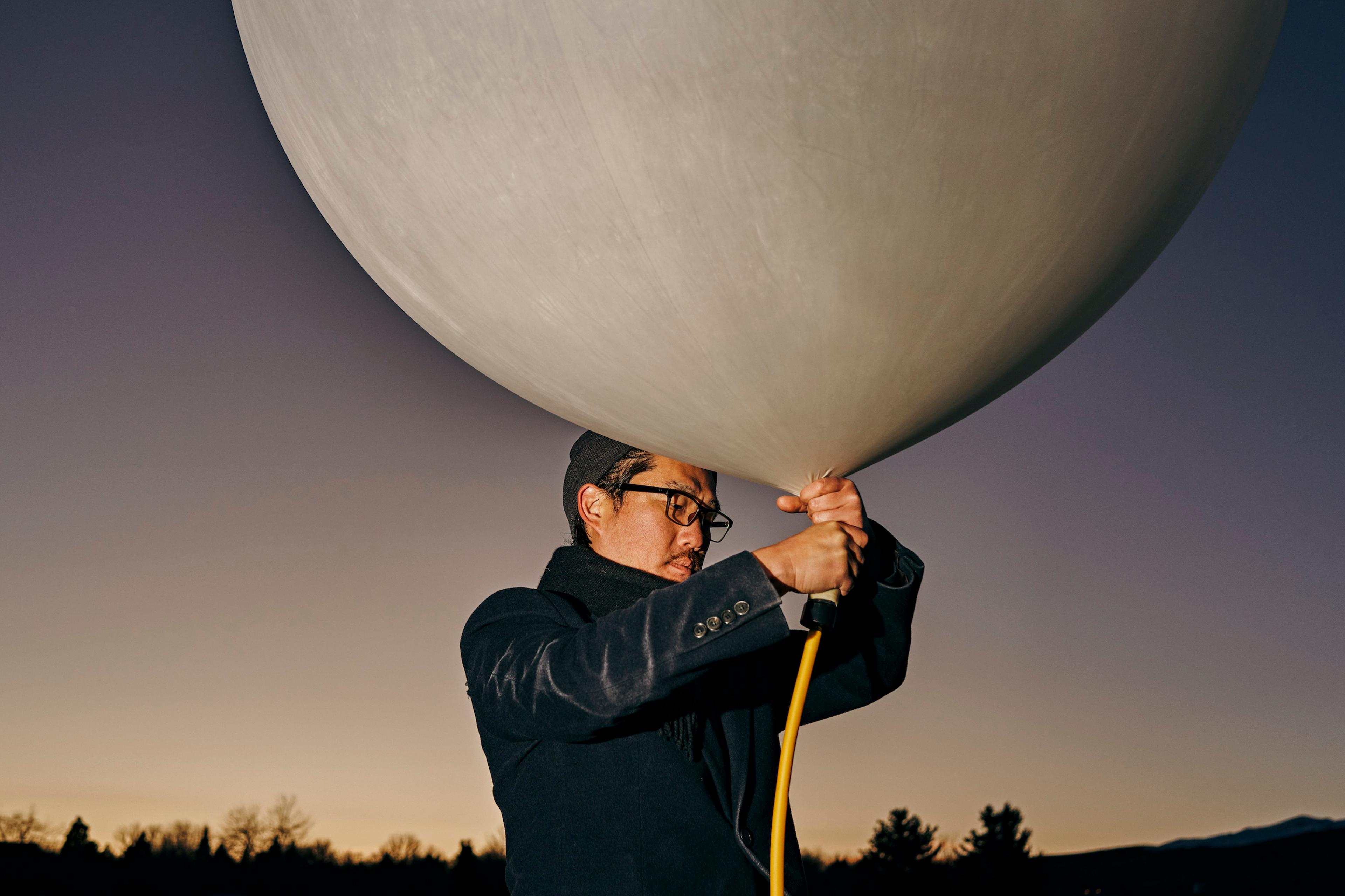 Co-founder Andrew Song of solar geoengineering startup Make Sunsets holds a weather balloon filled with helium, air and sulfur dioxide at a park in Reno, Nevada, United States on February 12, 2023.