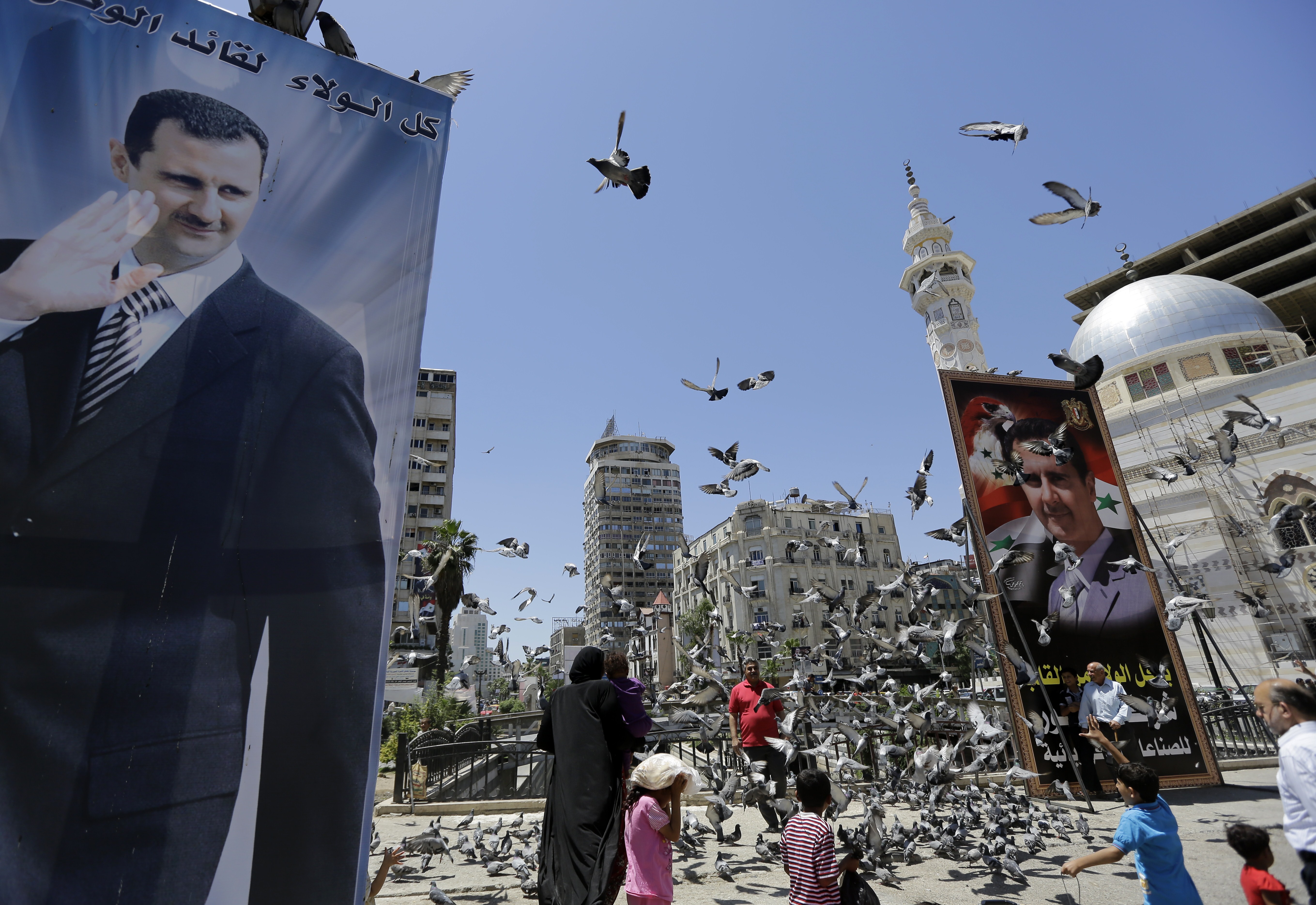 Portraits of Syrian President Bashar al-Assad on June 1, 2014 in the capital Damascus.