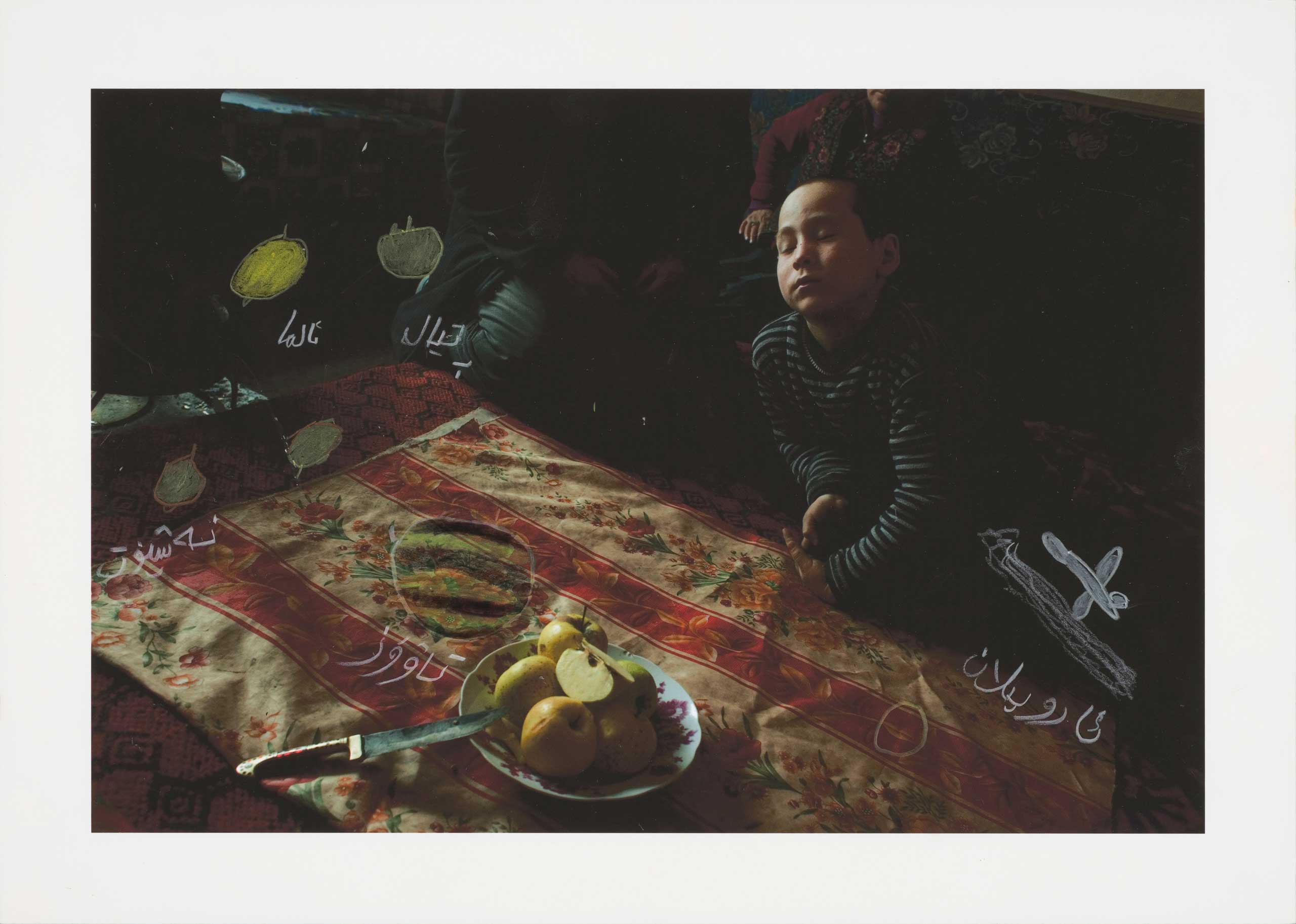 In 2011, I visited a family I had met a few years earlier in a village on the southern edge of the desert. I took pictures as we gathered around the table for lunch. When I returned with the print later that year, we again sat down in front of plates of 