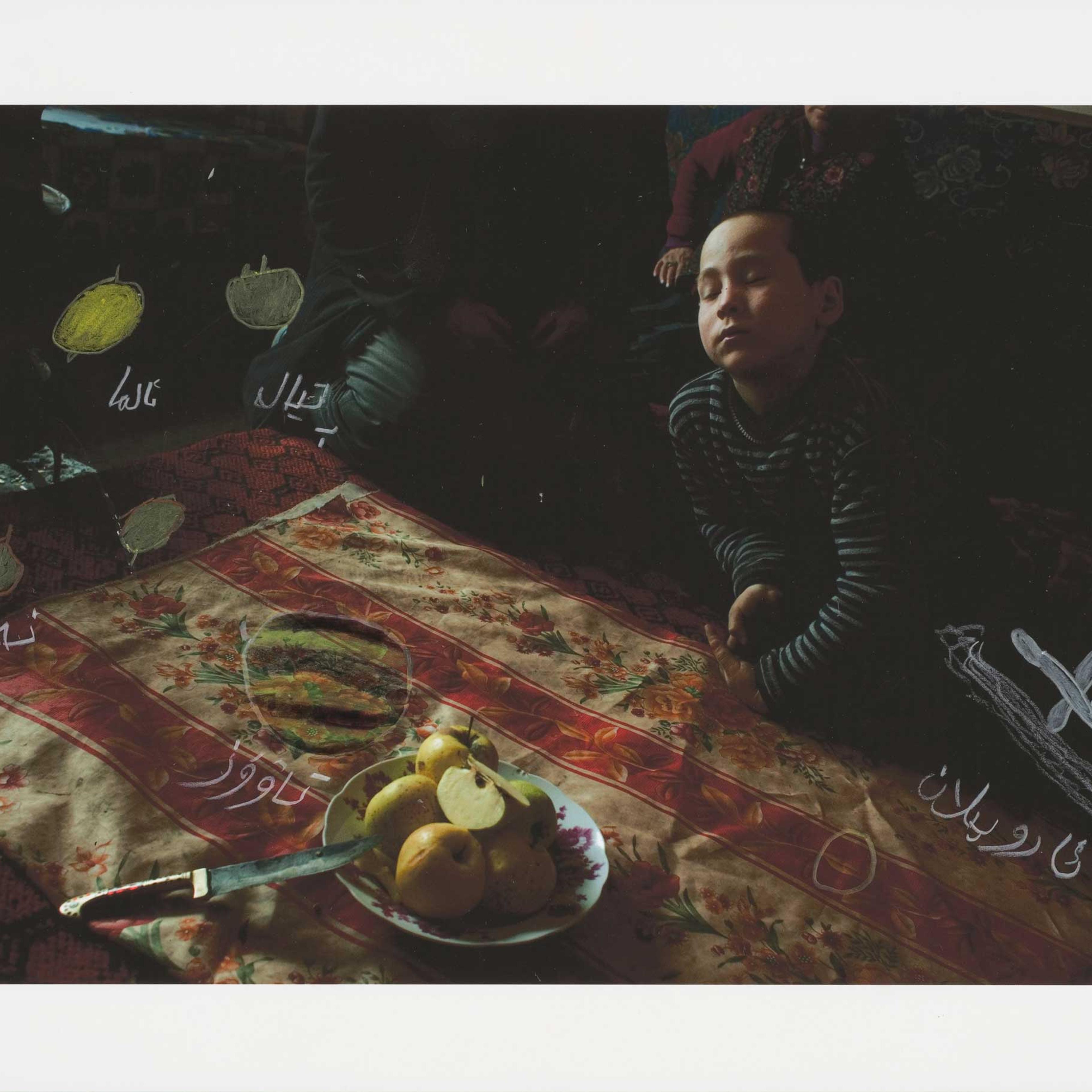 In 2011, I visited a family I had met a few years earlier in a village on the southern edge of the desert. I took pictures as we gathered around the table for lunch. When I returned with the print later that year, we again sat down in front of plates of