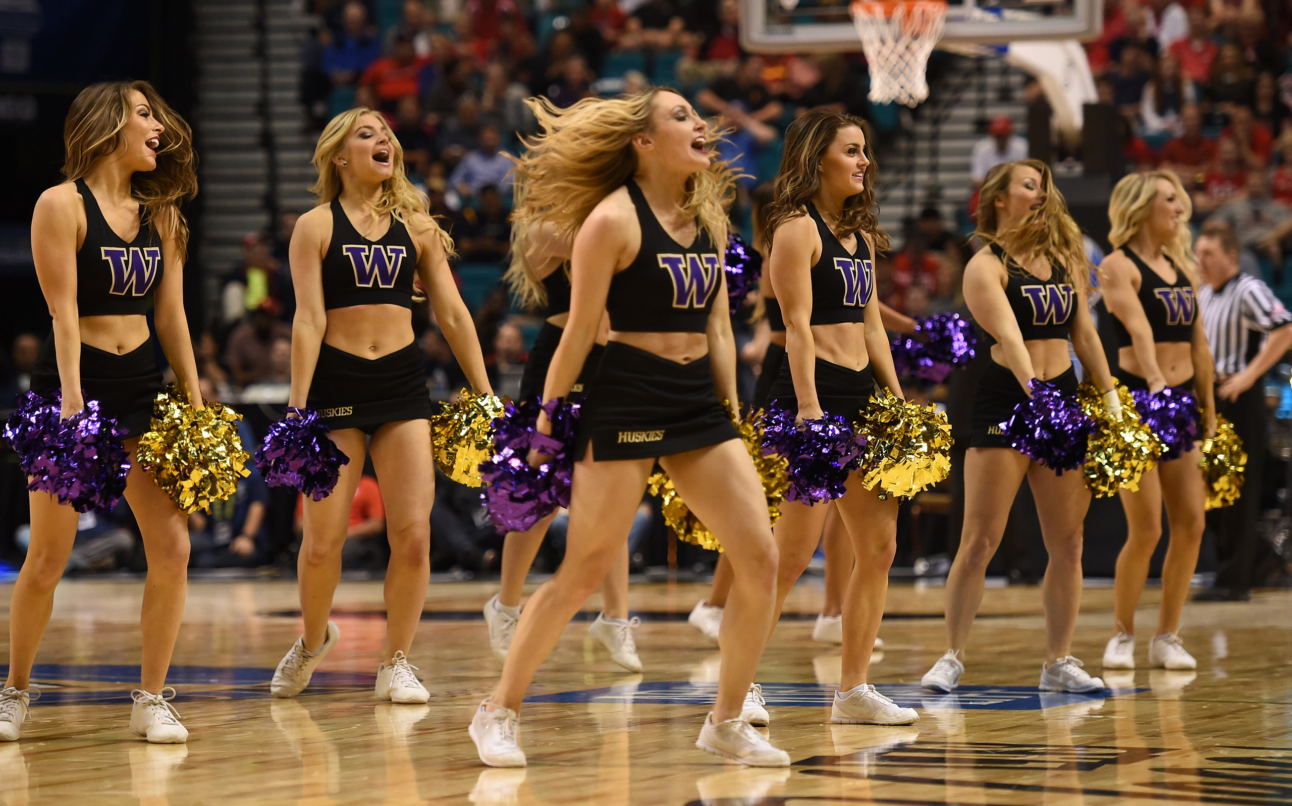 Washington Huskies cheerleaders perform during the team's quarterfinal game of the Pac-12 Basketball Tournament against the Oregon Ducks in Las Vegas, Nevada on March 10, 2016.