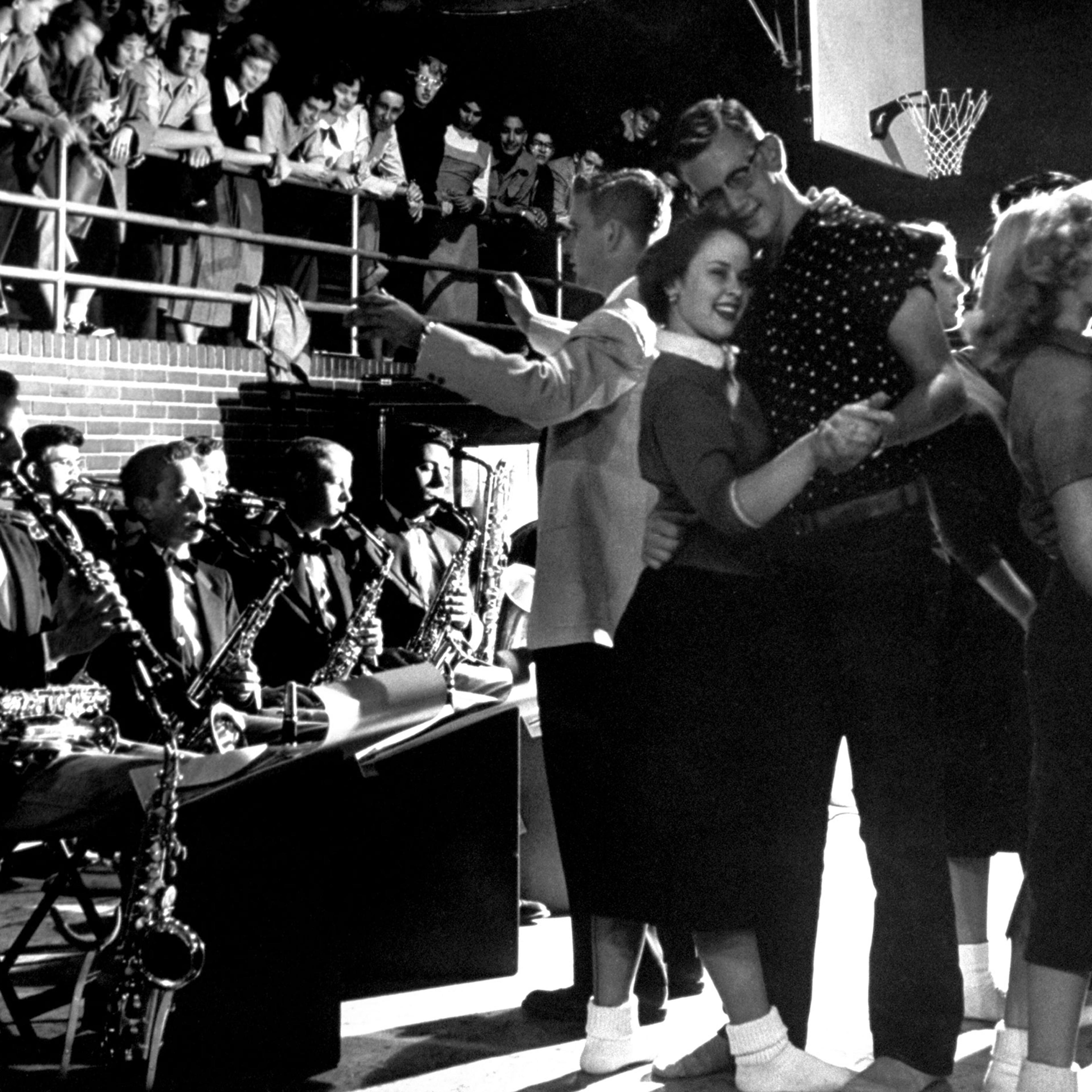 In aura of fun and well-being, students dance in gym of Carlsbad's high school at weekly "Sock Hop" to music of a 12-piece student band.