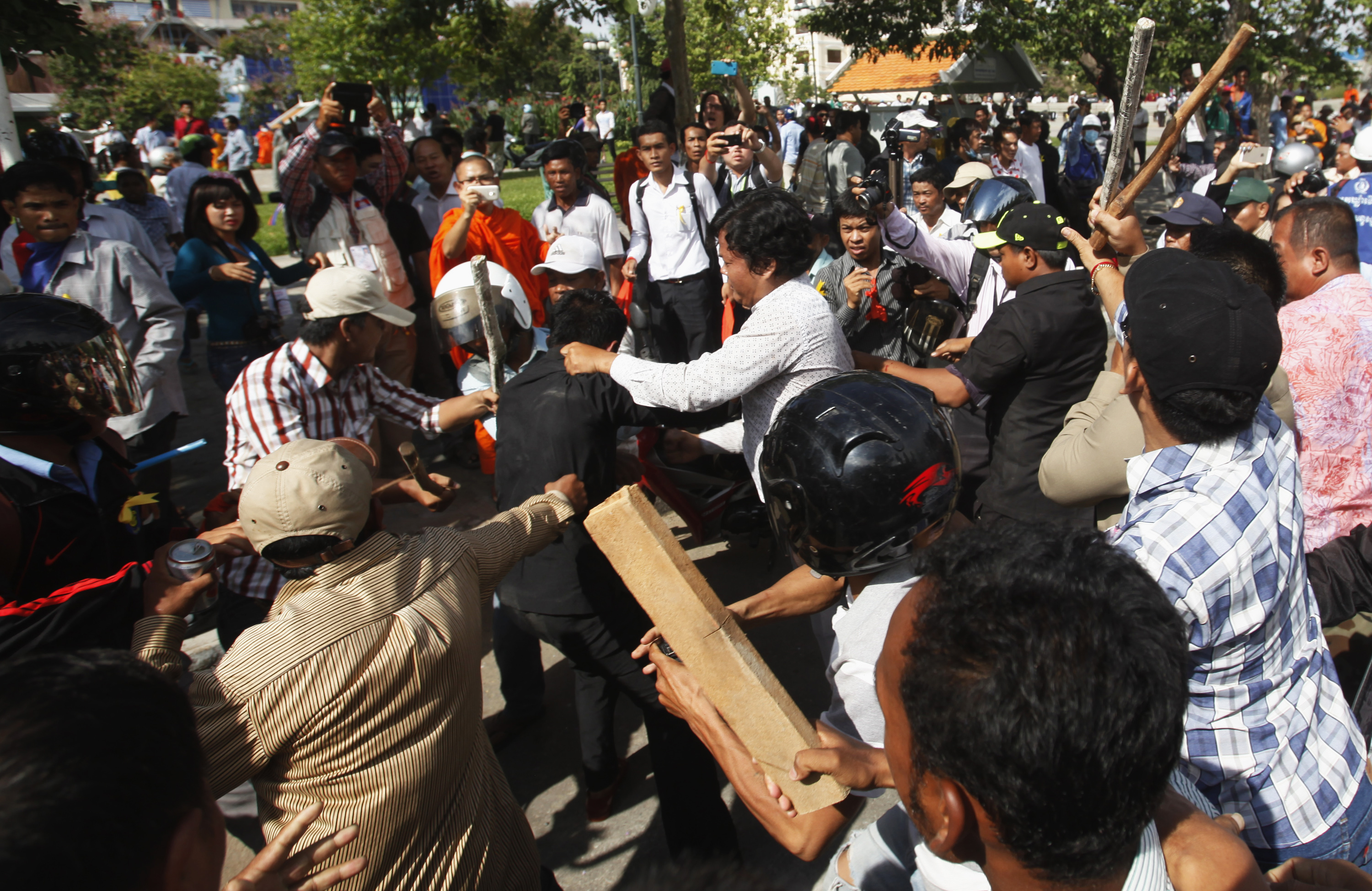 Police officers scuffle with protesters during clashes at Freedom Park in central Phnom Penh