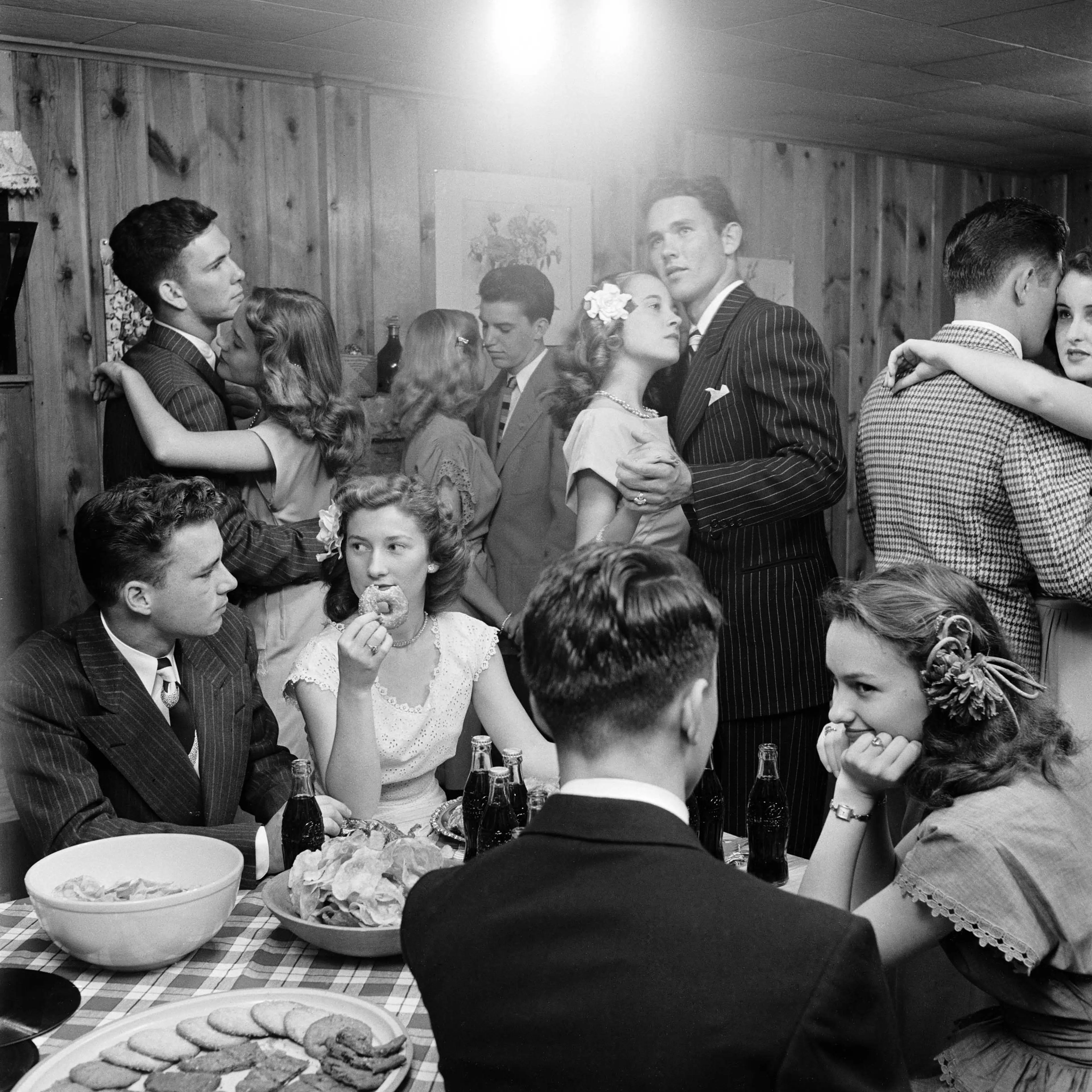 Teenagers at a party in 1947 in Tulsa, Oklahoma; LIFE reported that they "munch doughnuts and sip cokes whenever they are not dancing with serious faces to sentimental music."