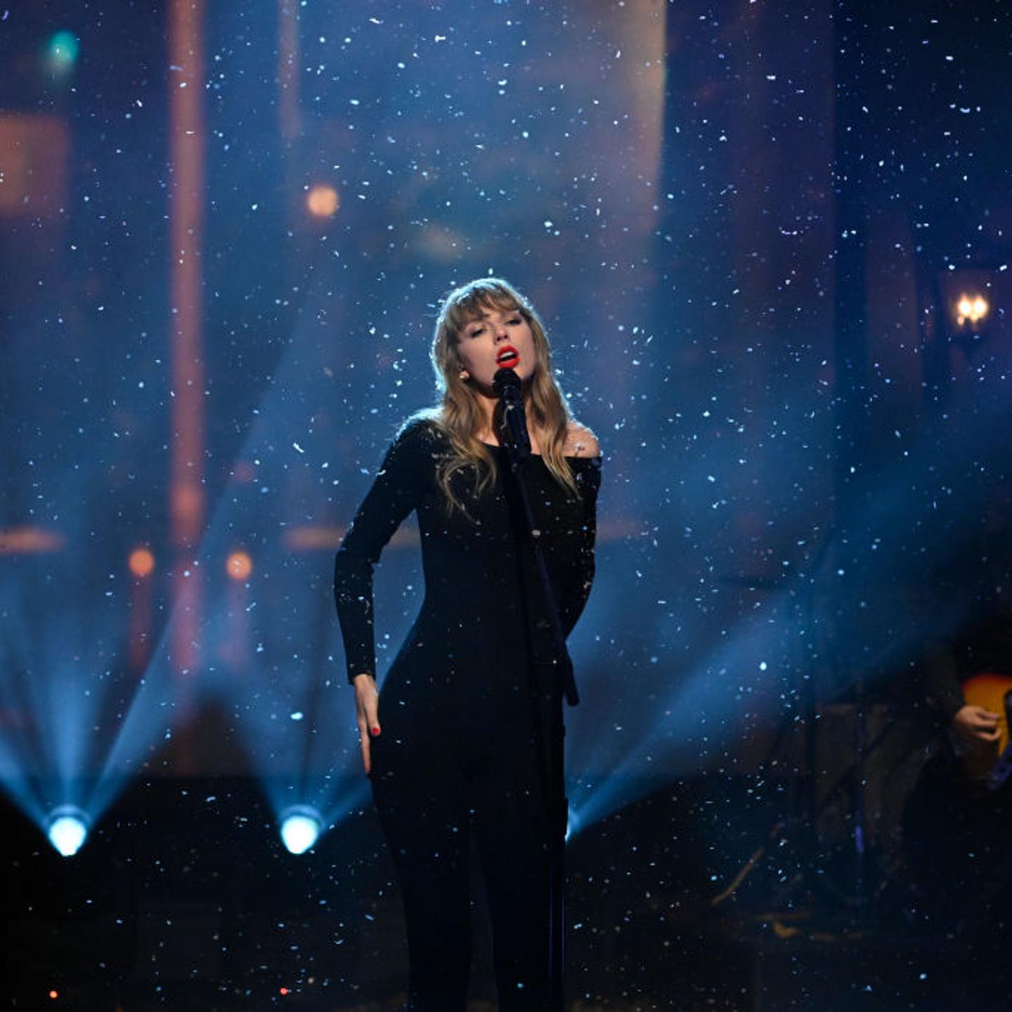 Taylor Swift in front of a microphone