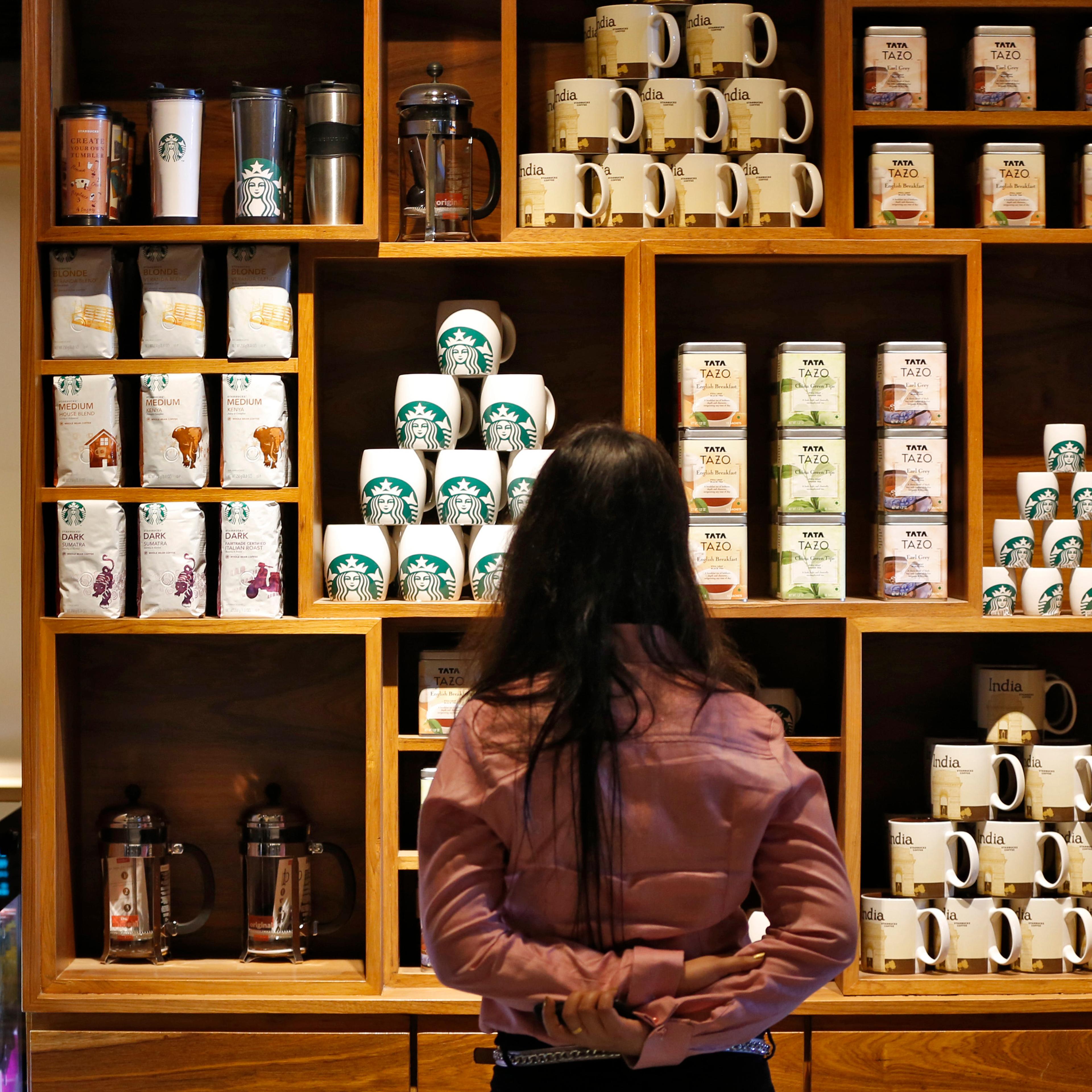 Visitor looks at products on display during the launch of the first Starbucks store in New Delhi