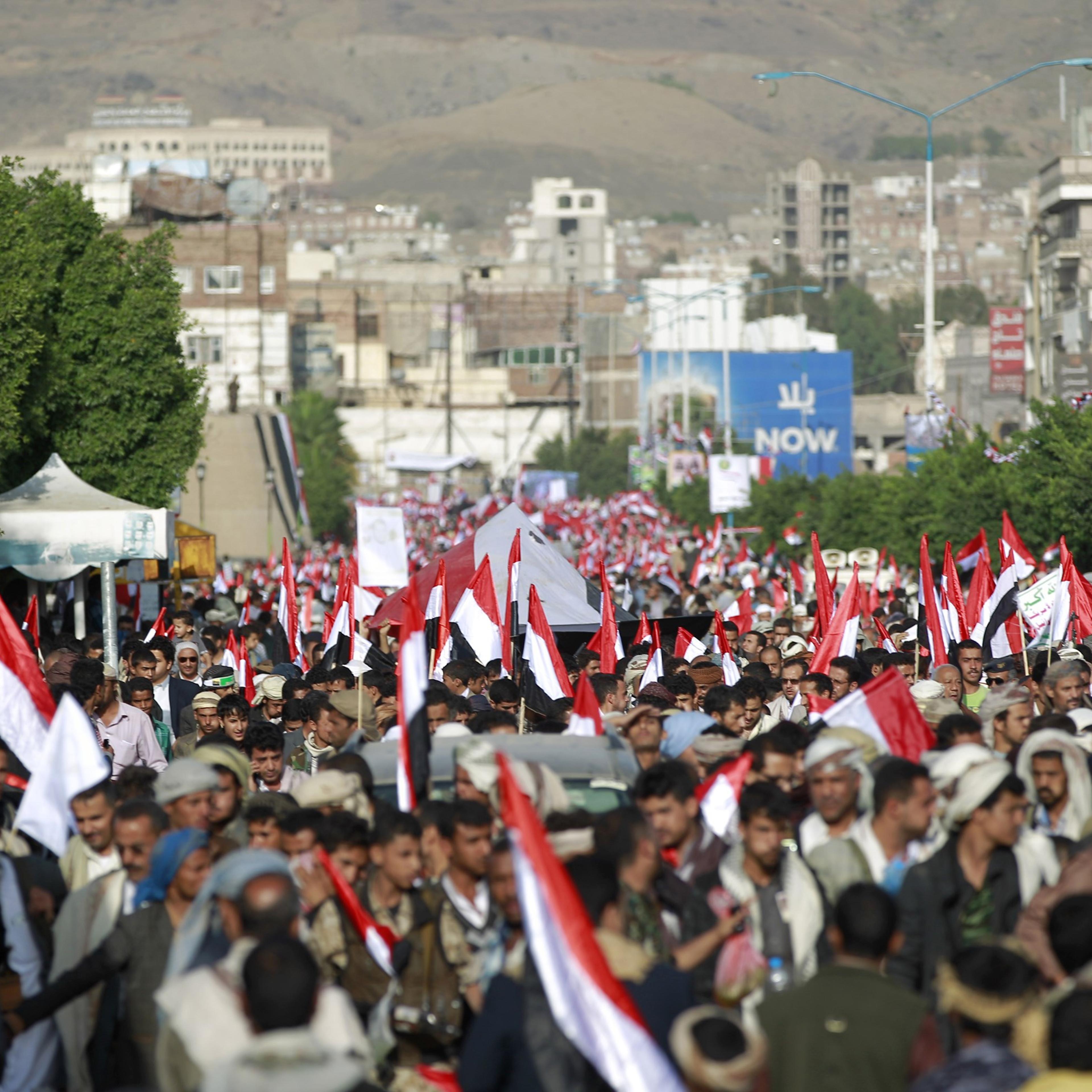 Yemeni supporters of the Shiite Huthi rebel movement hold national flags in the capital Sanaa on Sept. 21, 2015.