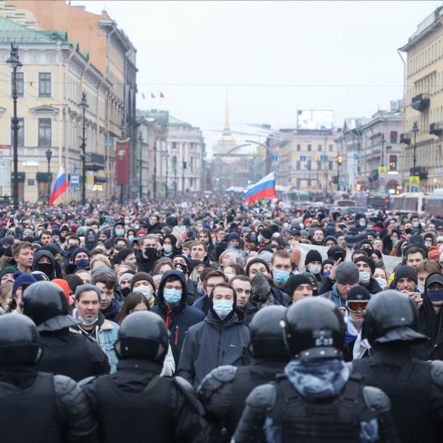 Police officers confront crowds of protesters during the