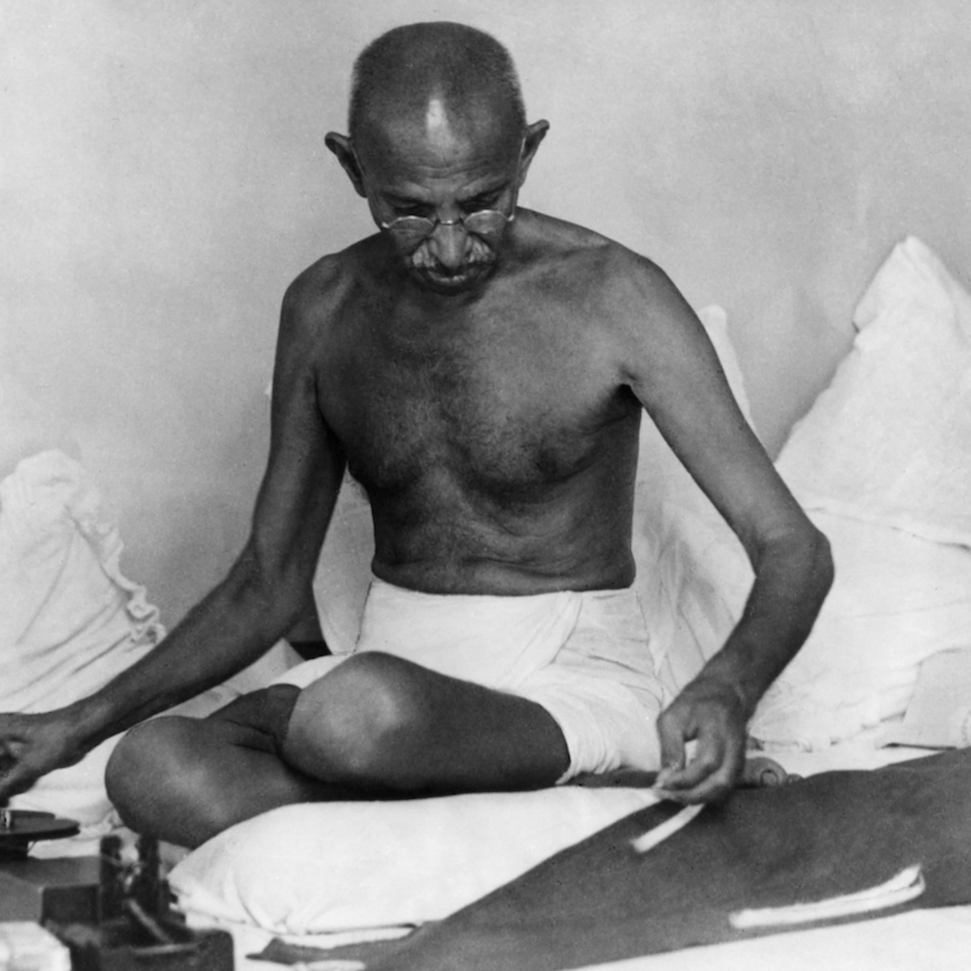 MOHANDAS GANDHI (1869-1948). Hindu nationalist and spiritual leader. Spinning cloth, 1942.