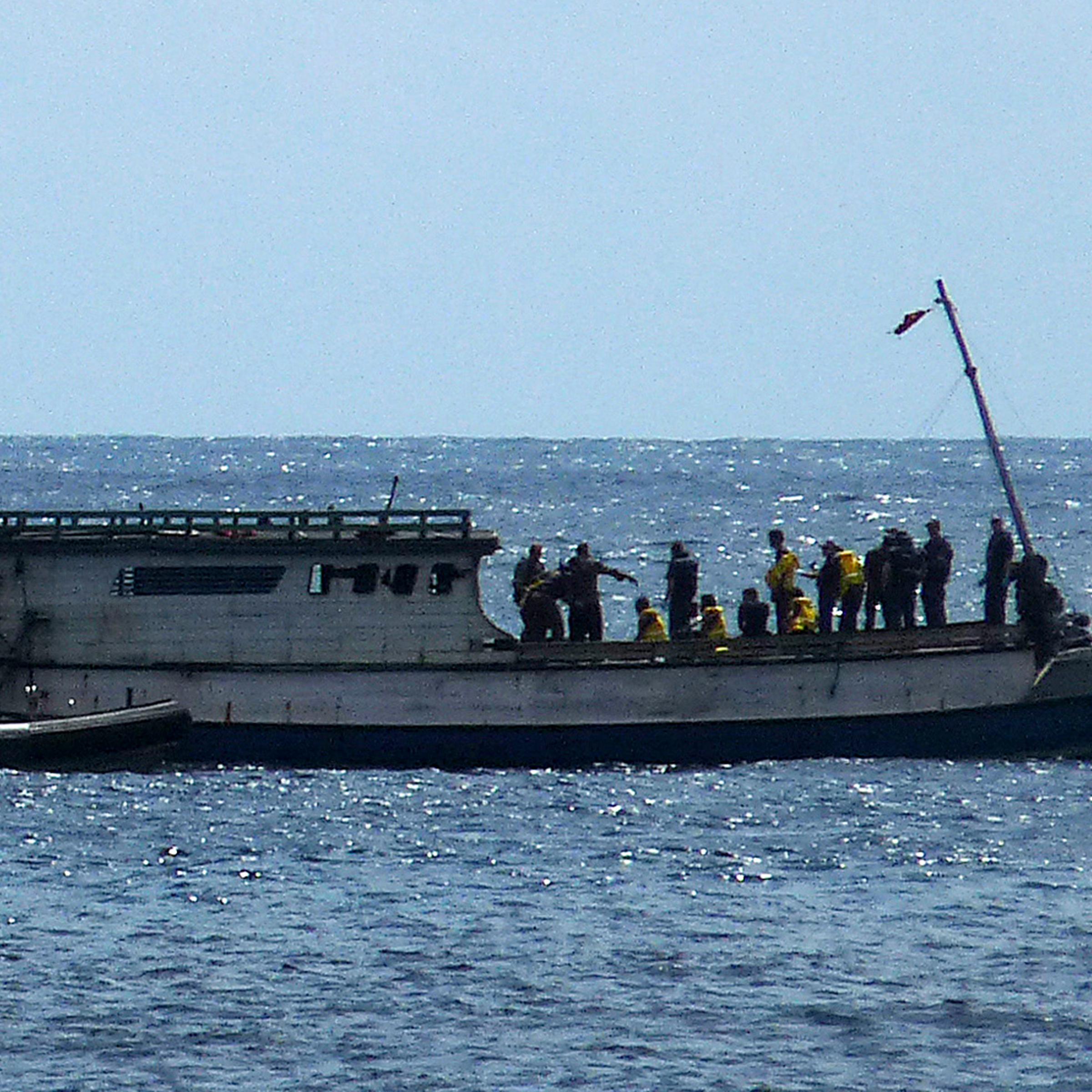 Australian Navy boat comes alongside a boat carrying 50 asylum seekers after it arrived at Flying Fish Cove on Christmas Island