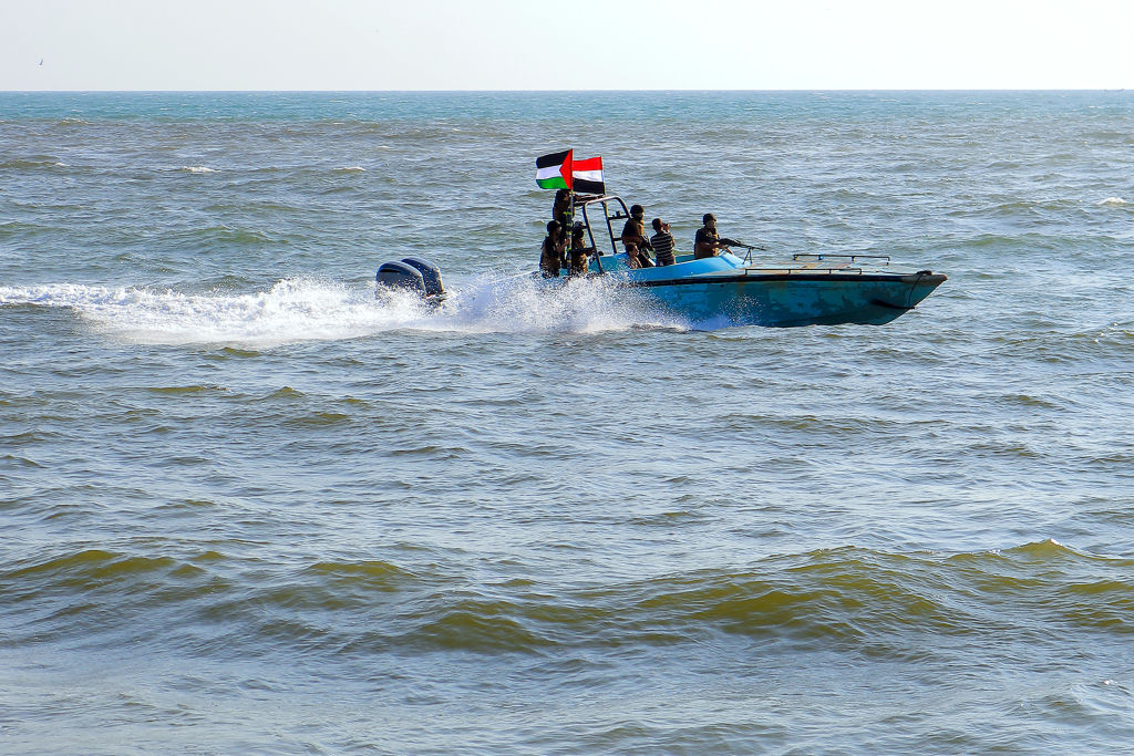 Members of the Yemeni Coast Guard affiliated with the Houthi group patrol the sea as demonstrators march through the Red Sea port city of Hodeida in solidarity with the people of Gaza on Jan. 4, 2024, amid the ongoing battles between Israel and the milit