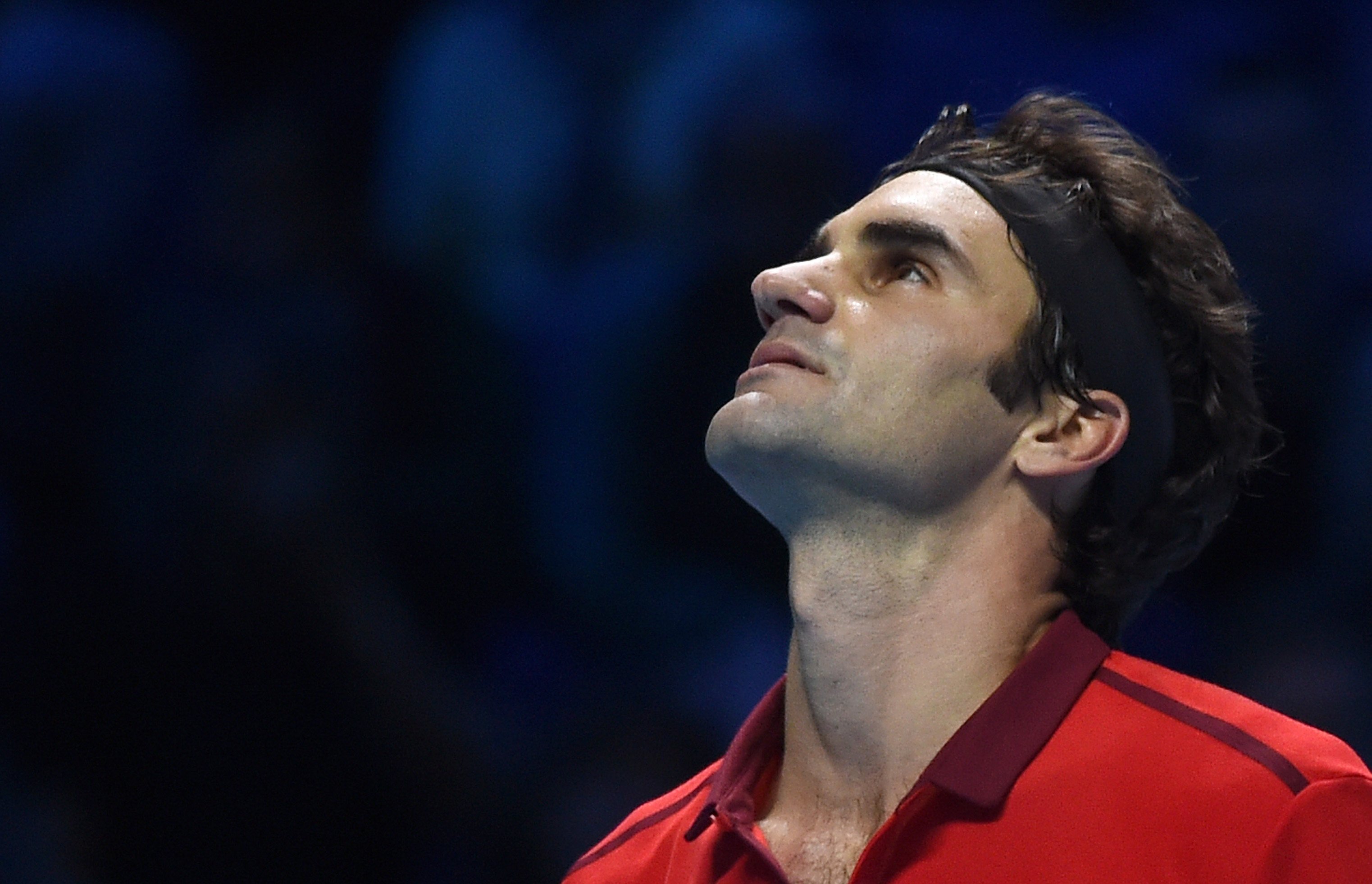 Roger Federer looks up during his singles ATP World Tour Finals semifinal tennis match against Switzerlands Stan Wawrinka at the O2 Arena in London on Nov. 15, 2014.