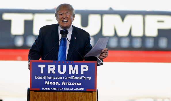 Republican presidential candidate Donald Trump speaks to guests gathered during a campaign event at the International Air Response facility on December 16, 2015 in Mesa, Arizona.