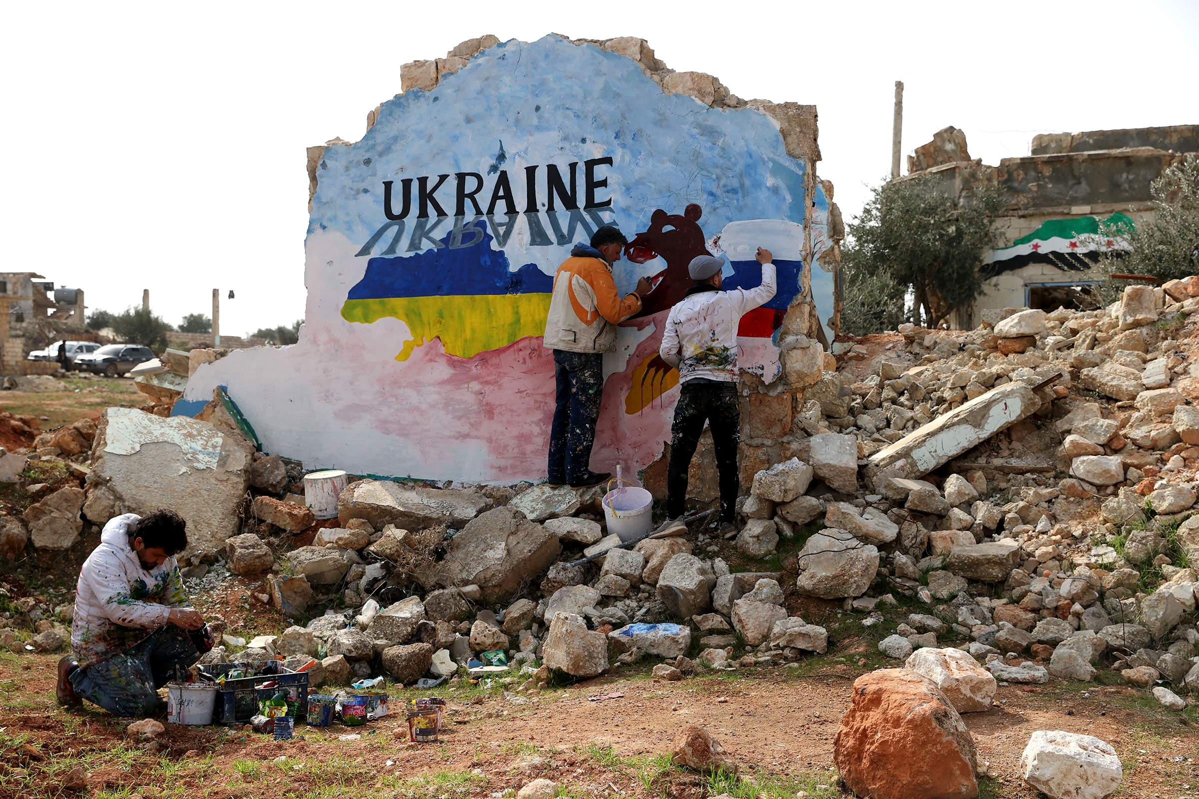 Syrian artists paint a mural in protest against Russia's military operation in Ukraine.