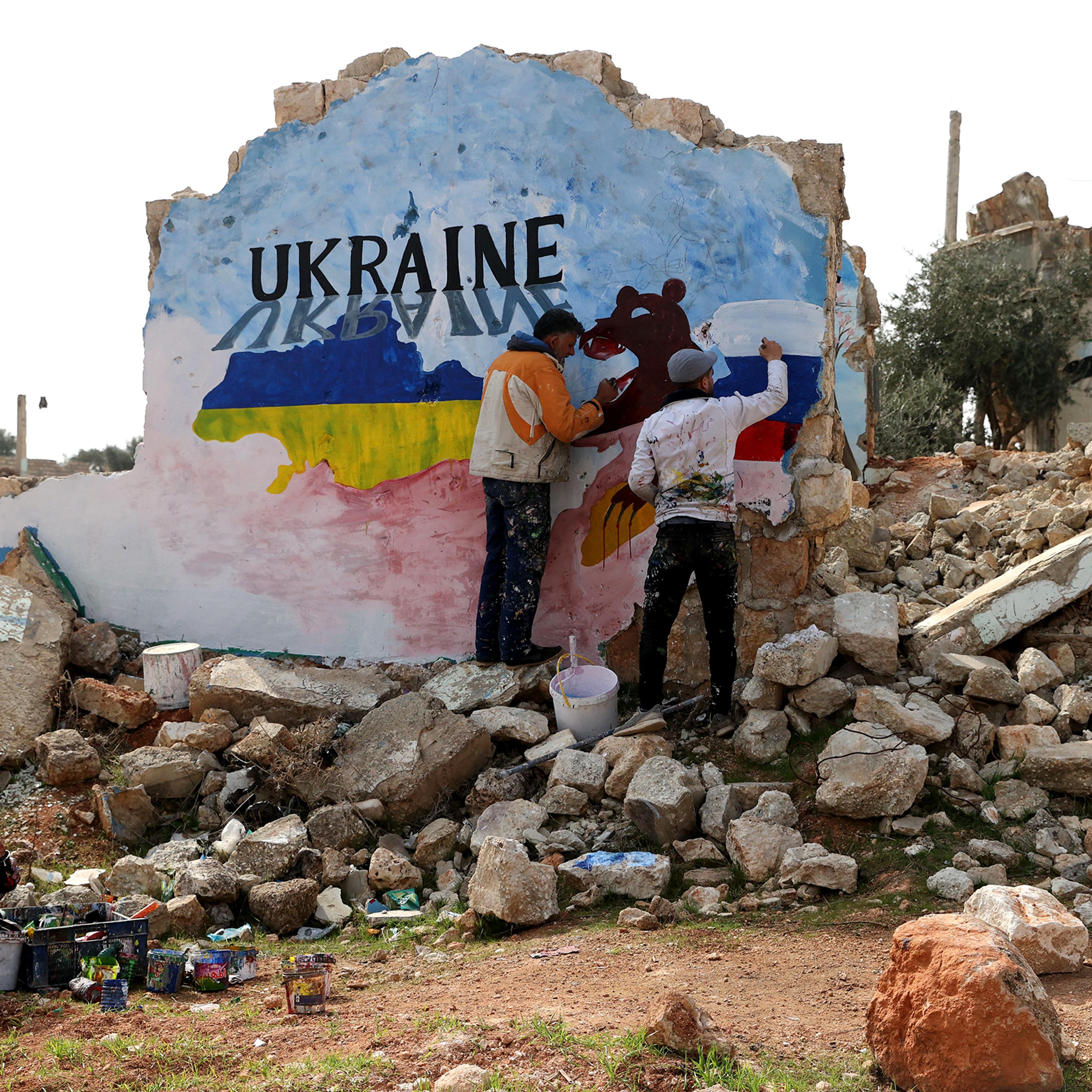 Syrian artists paint a mural in protest against Russia's military operation in Ukraine.