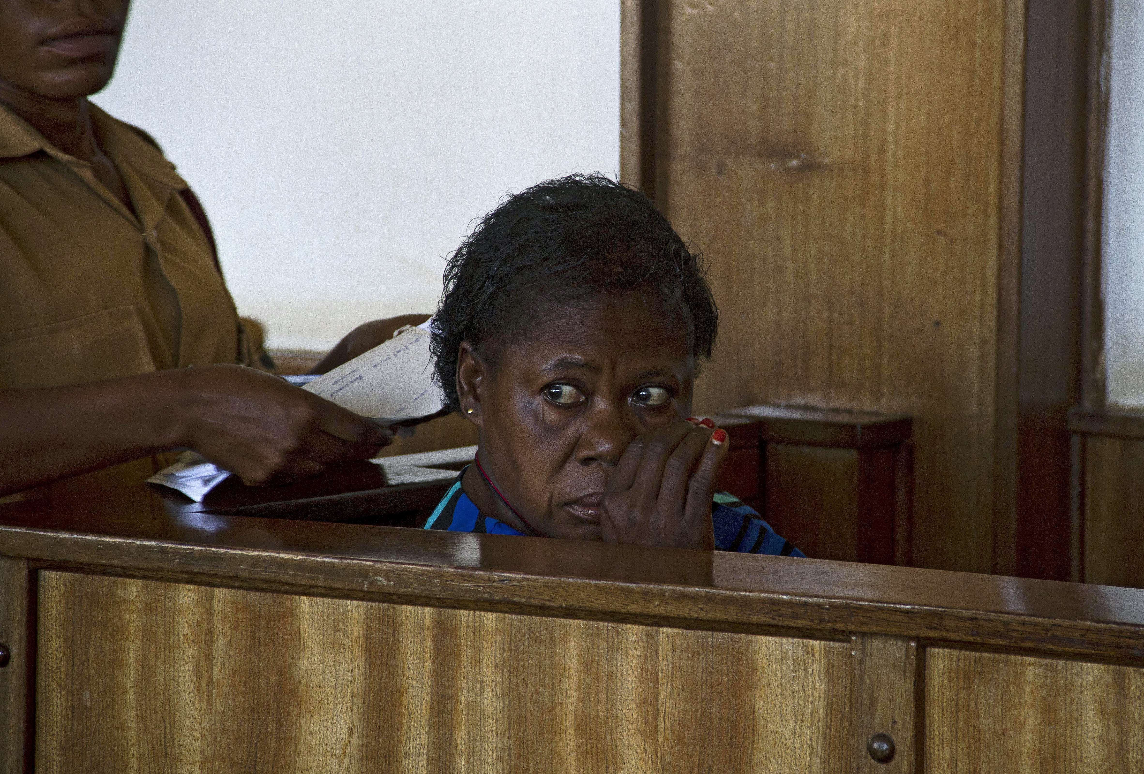 Ugandan nurse Rosemary Namubiru sits at the dock at the Buganda Road Magistrates Court on May 19, 2014 in Kampala during a ruling on a case where she was charged with "Criminal Negligence" and sentenced to 3 years in prison after she was found guilty by 