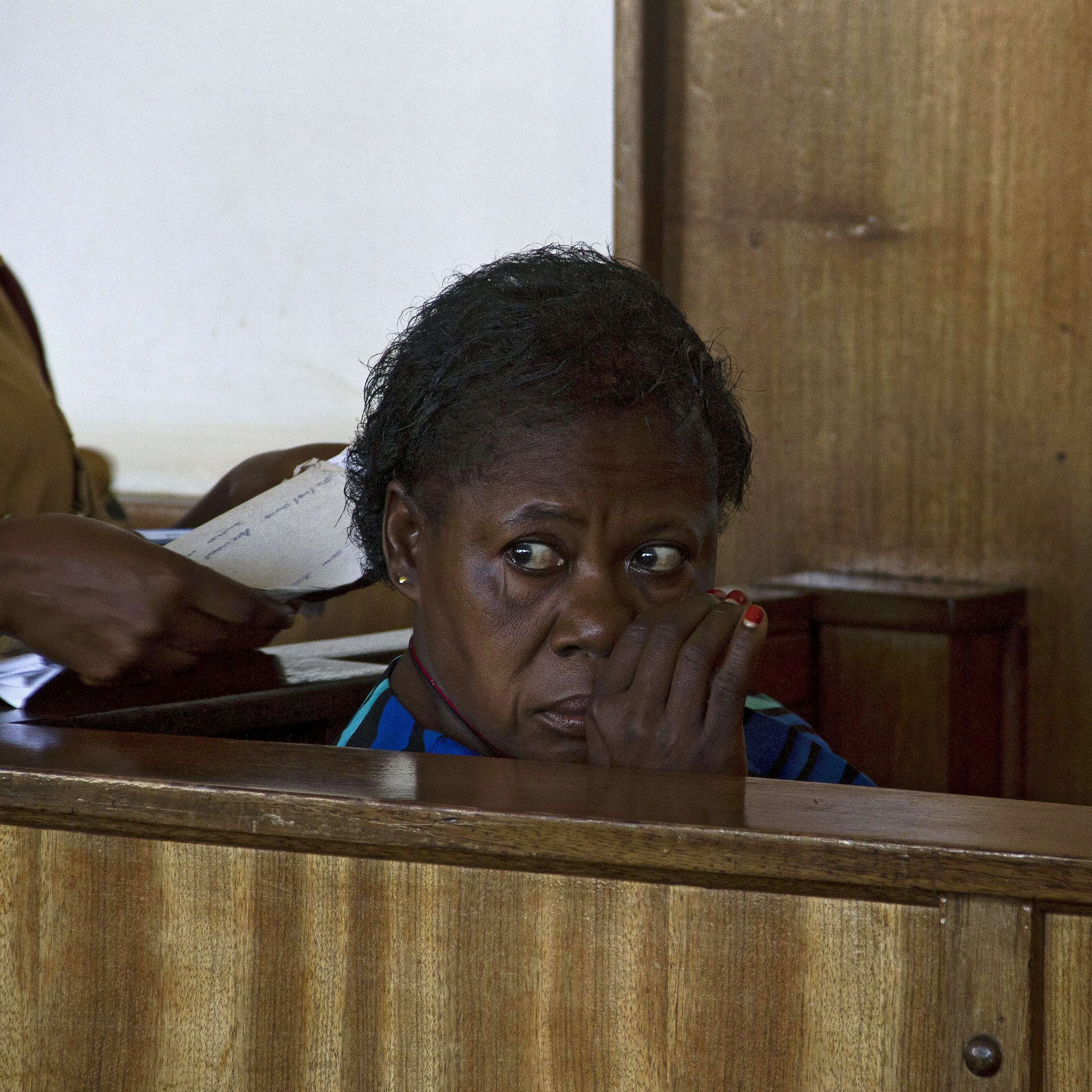 Ugandan nurse Rosemary Namubiru sits at the dock at the Buganda Road Magistrates Court on May 19, 2014 in Kampala during a ruling on a case where she was charged with "Criminal Negligence" and sentenced to 3 years in prison after she was found guilty by