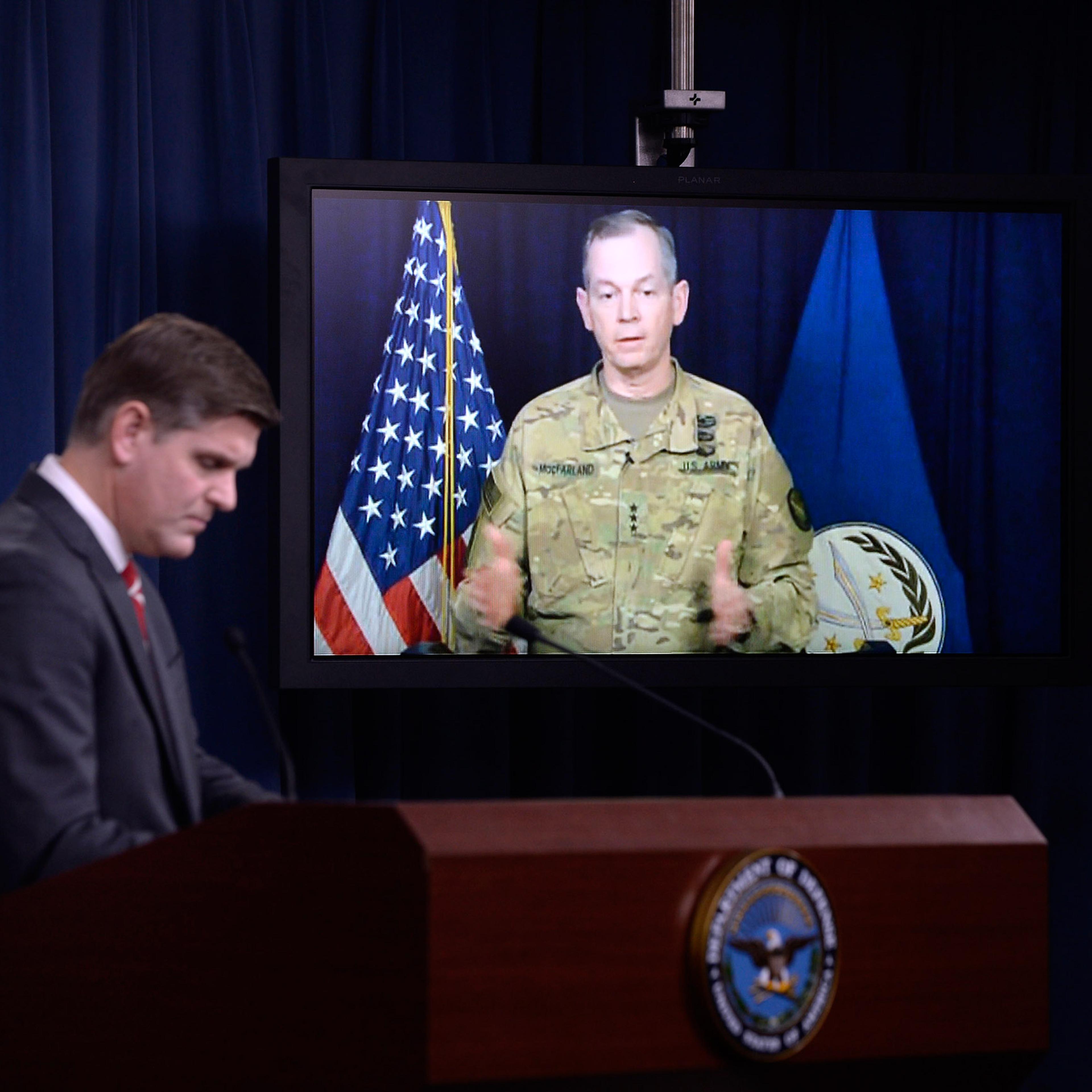 ARLINGTON, VA - FEBRUARY 1: Combined Joint Task Force Commander Army Lt. Gen. Sean MacFarland speaks via teleconference from Baghdad, Iraq as Pentagon Press Secretary Peter Cook listens during a media briefing at the Pentagon to update operations on Oper