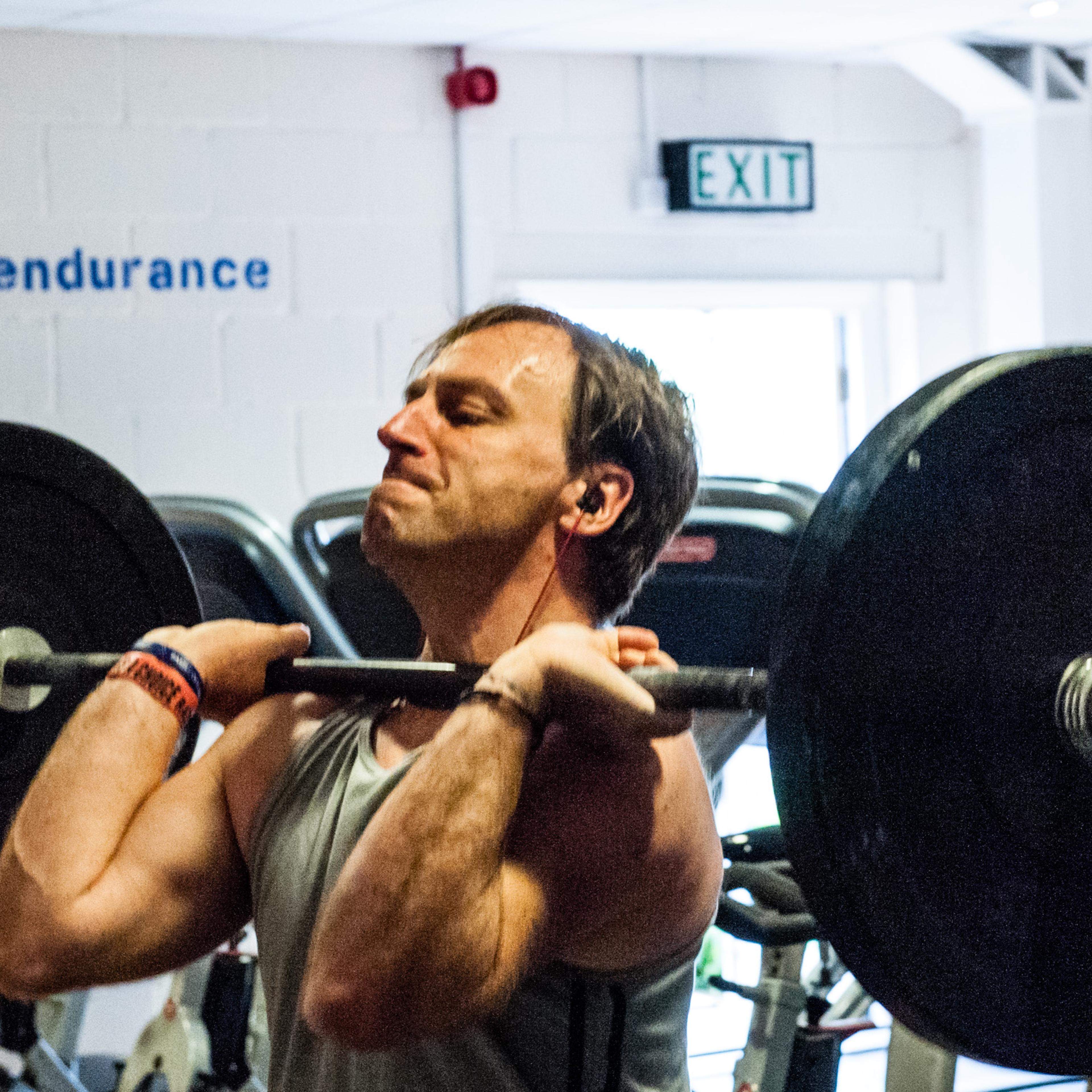 Man lifting weights at Kent and Sussex Crossfit.