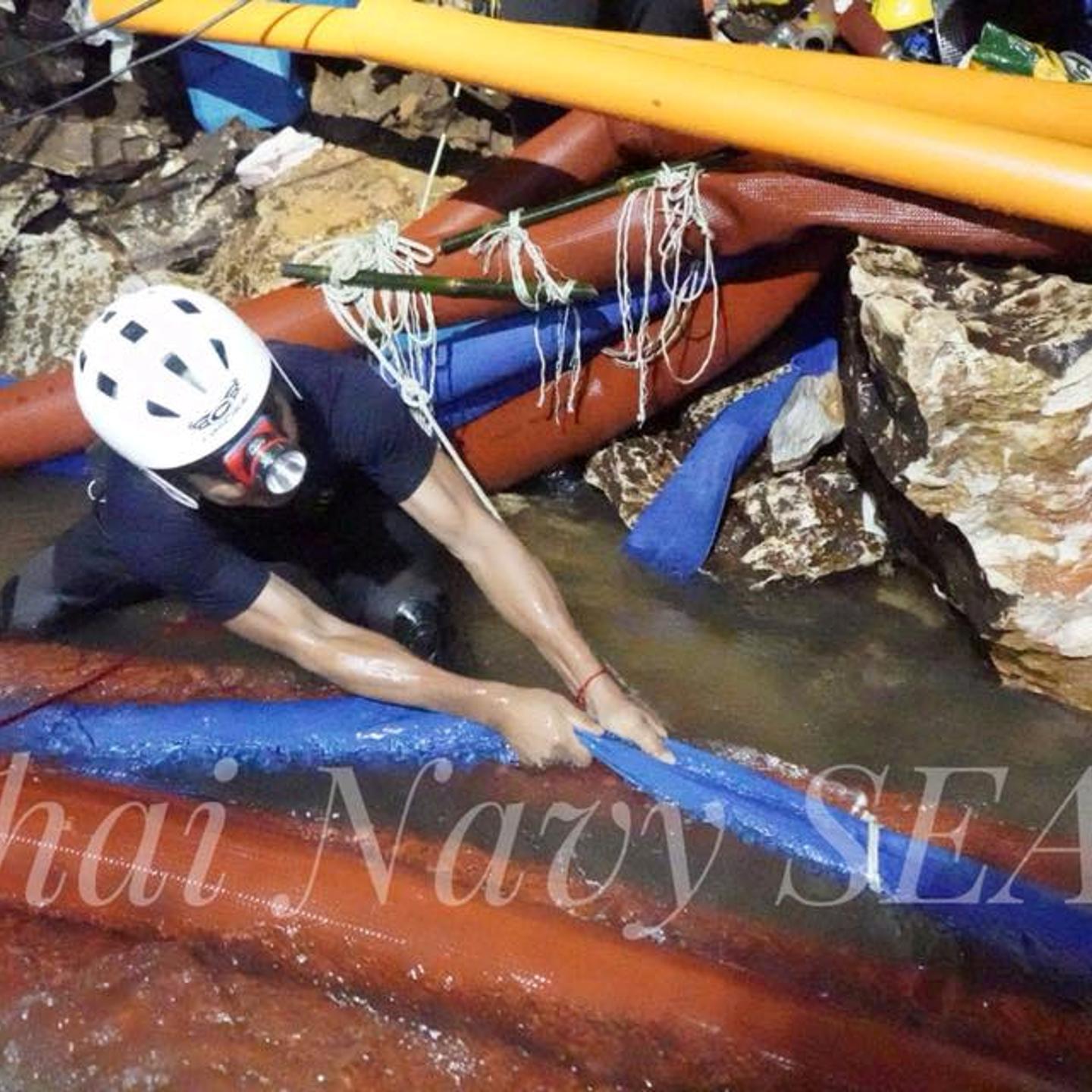 Rescue personnel work at the Tham Luang cave complex, as members of an under-16 soccer team and their coach have been found alive according to local media, in the northern province of Chiang Rai