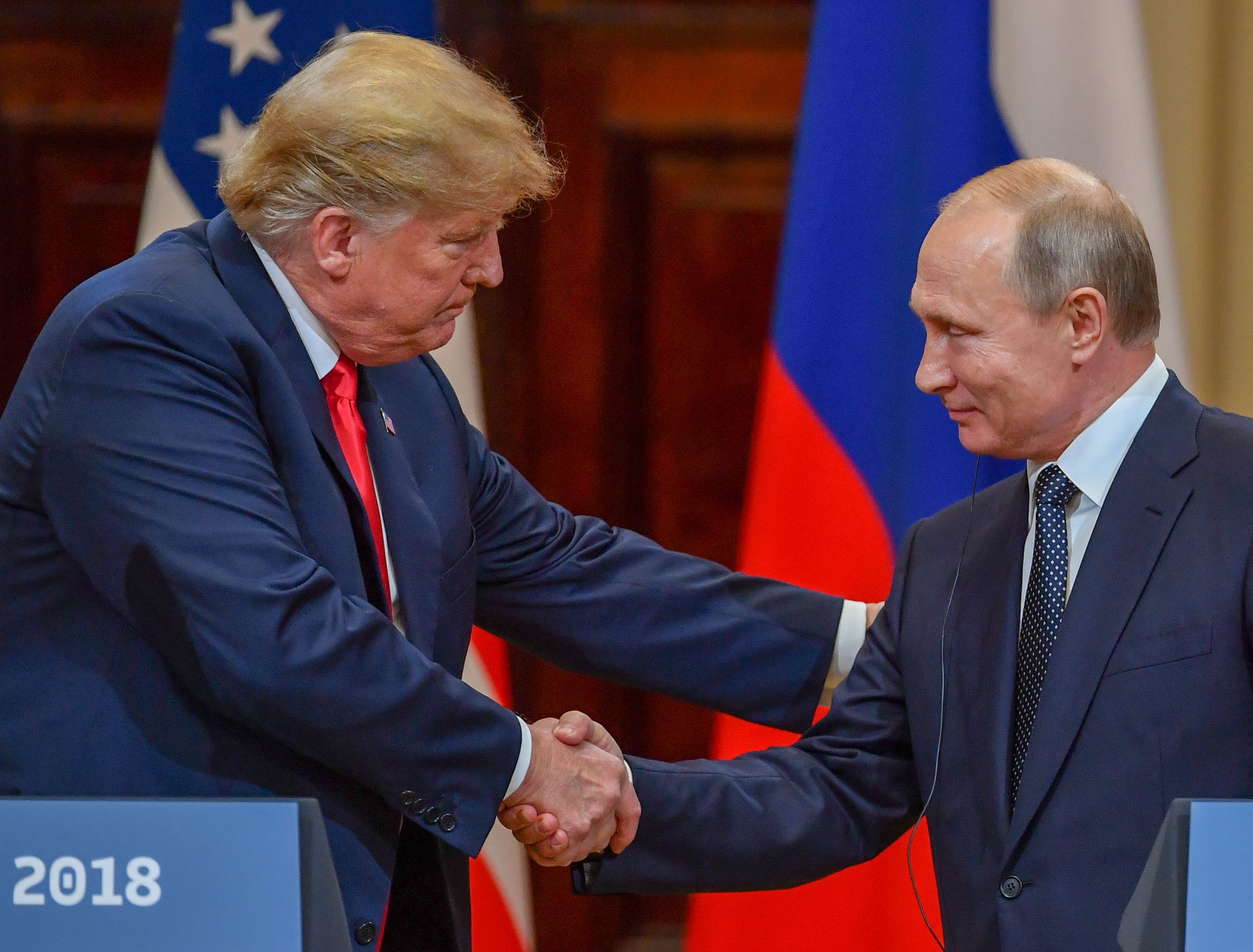 JULY 16 - US President Donald Trump  and Russia's President Vladimir Putin shake hands before attending a joint press conference after a meeting at the Presidential Palace in Helsinki.