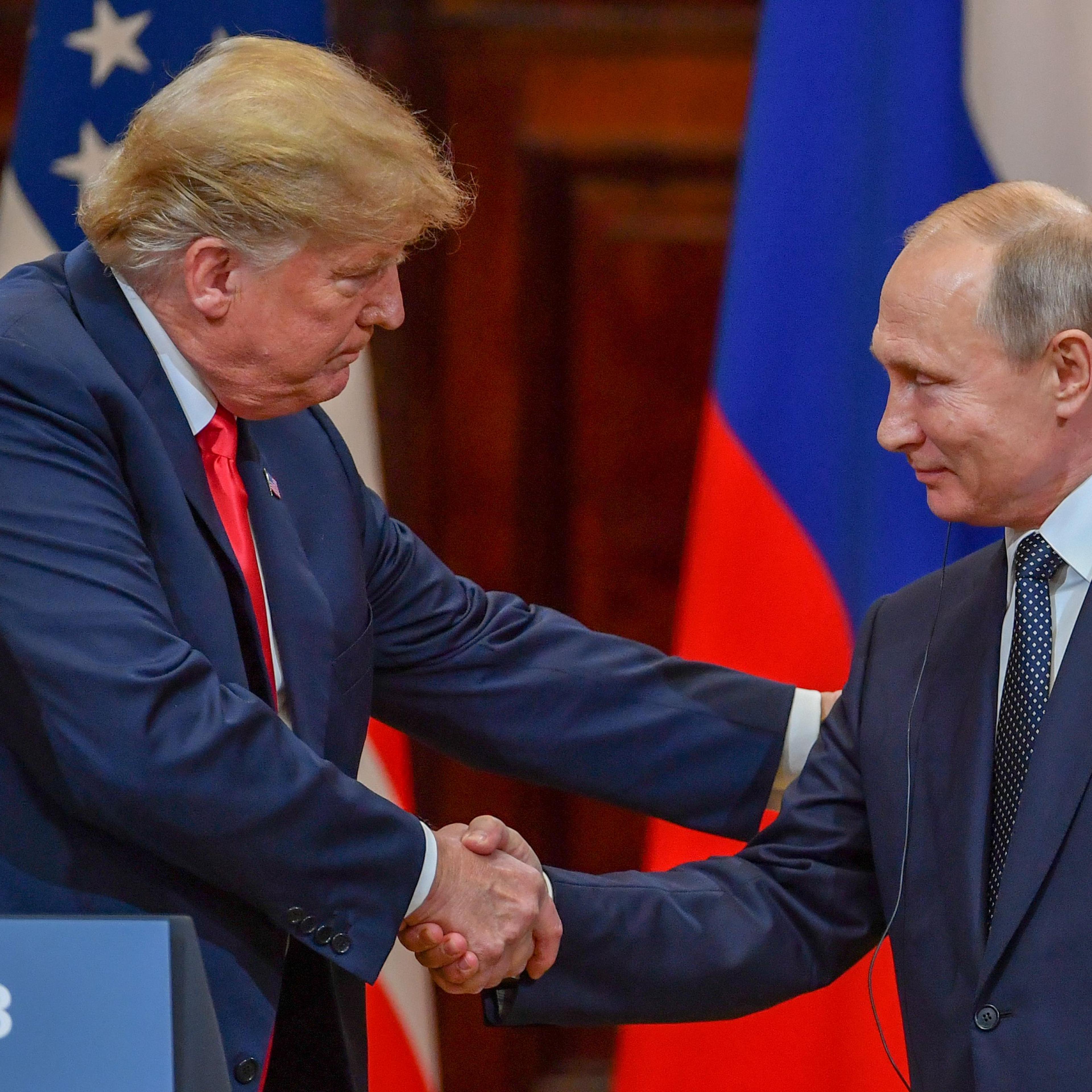 JULY 16 - US President Donald Trump and Russia's President Vladimir Putin shake hands before attending a joint press conference after a meeting at the Presidential Palace in Helsinki.