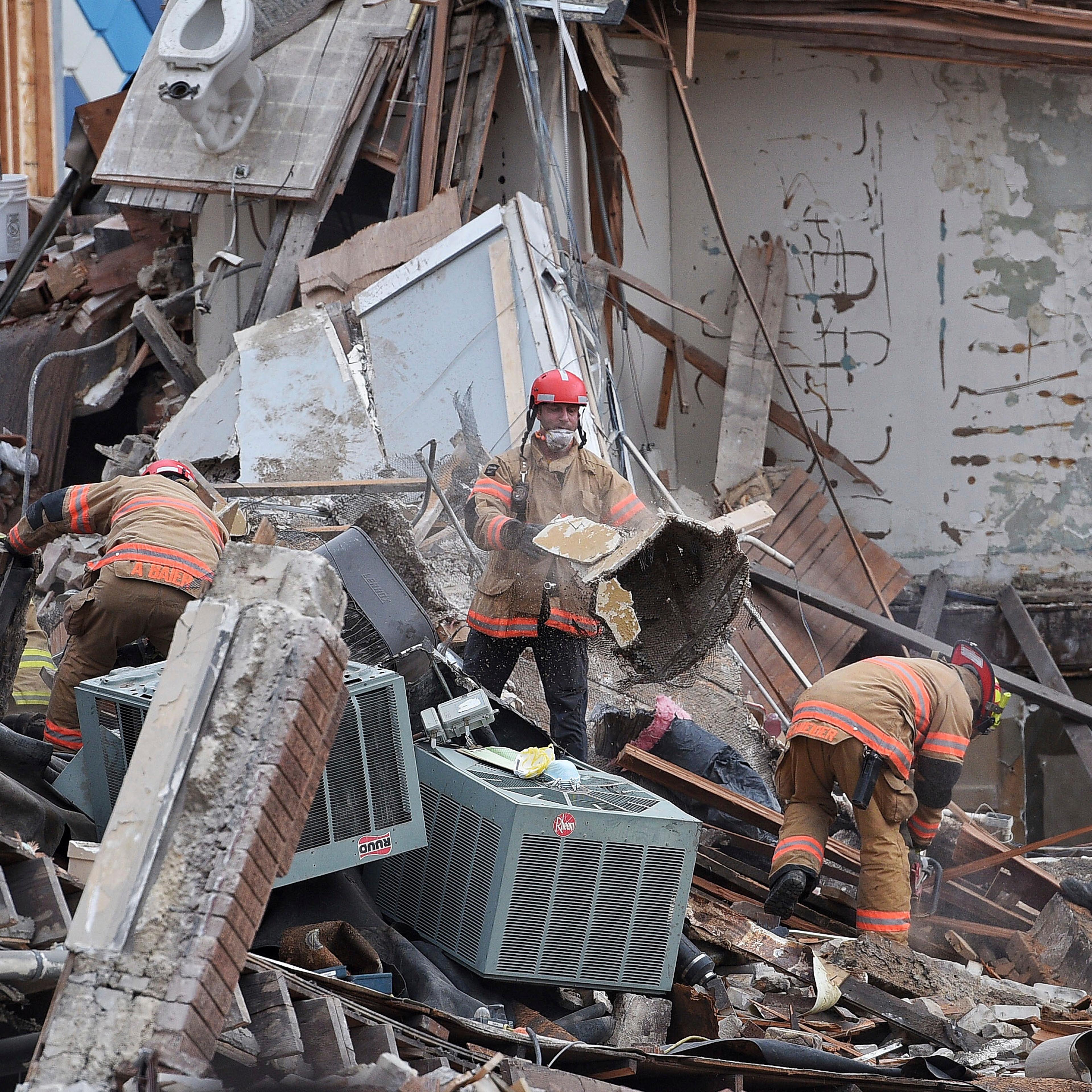 Emergency crews clear debris at the scene of building collapse in Sioux Falls, S.D., Dec. 2, 2016.