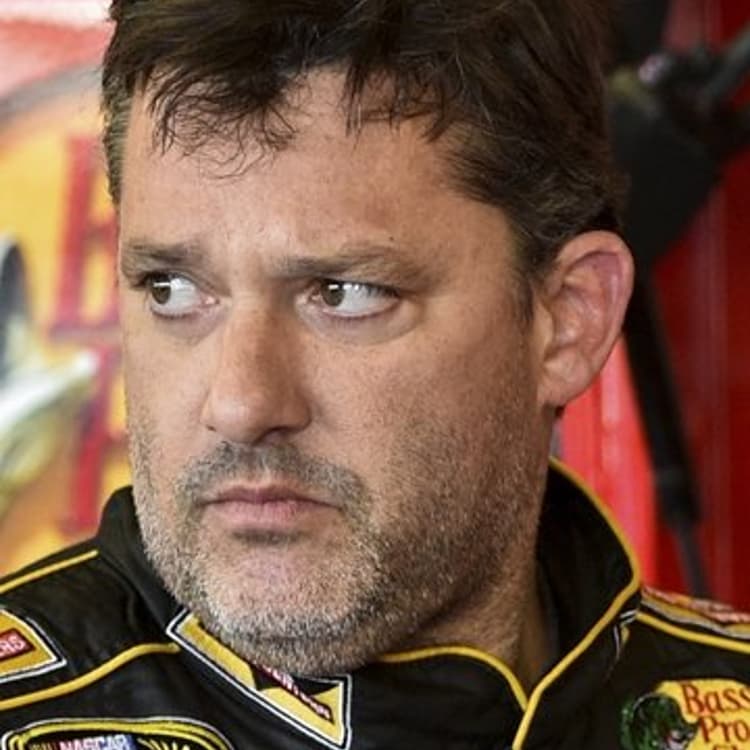 Tony Stewart stands in the garage area after a practice session for Sunday's NASCAR Sprint Cup Series auto race at Watkins Glen International, in Watkins Glen, N.Y on August 8, 2014.