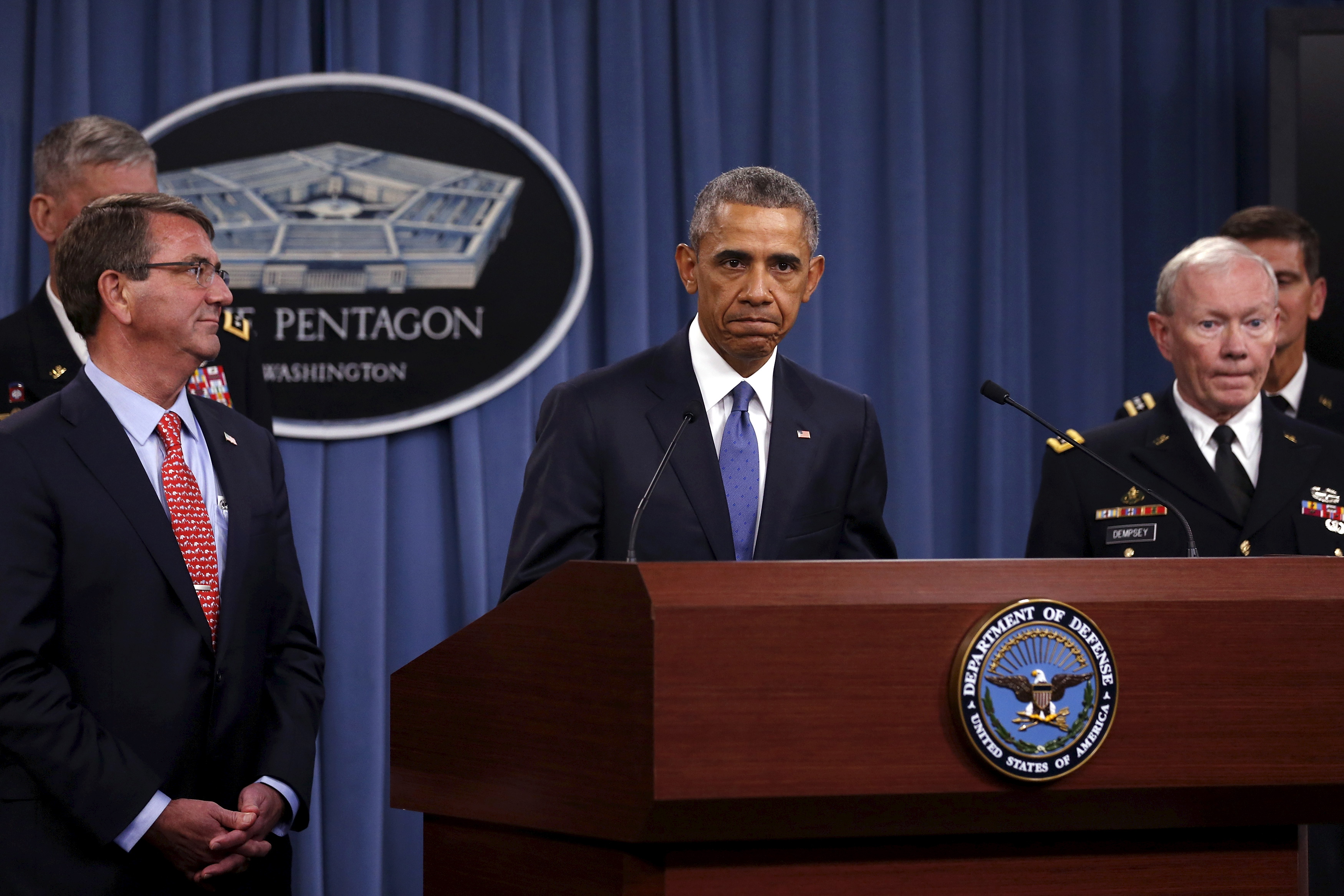 Obama, flanked by Carter and Dempsey, pauses as he delivers remarks after a briefing on U.S. efforts against the Islamic State (ISIS), at the Pentagon in Arlington, Virginia