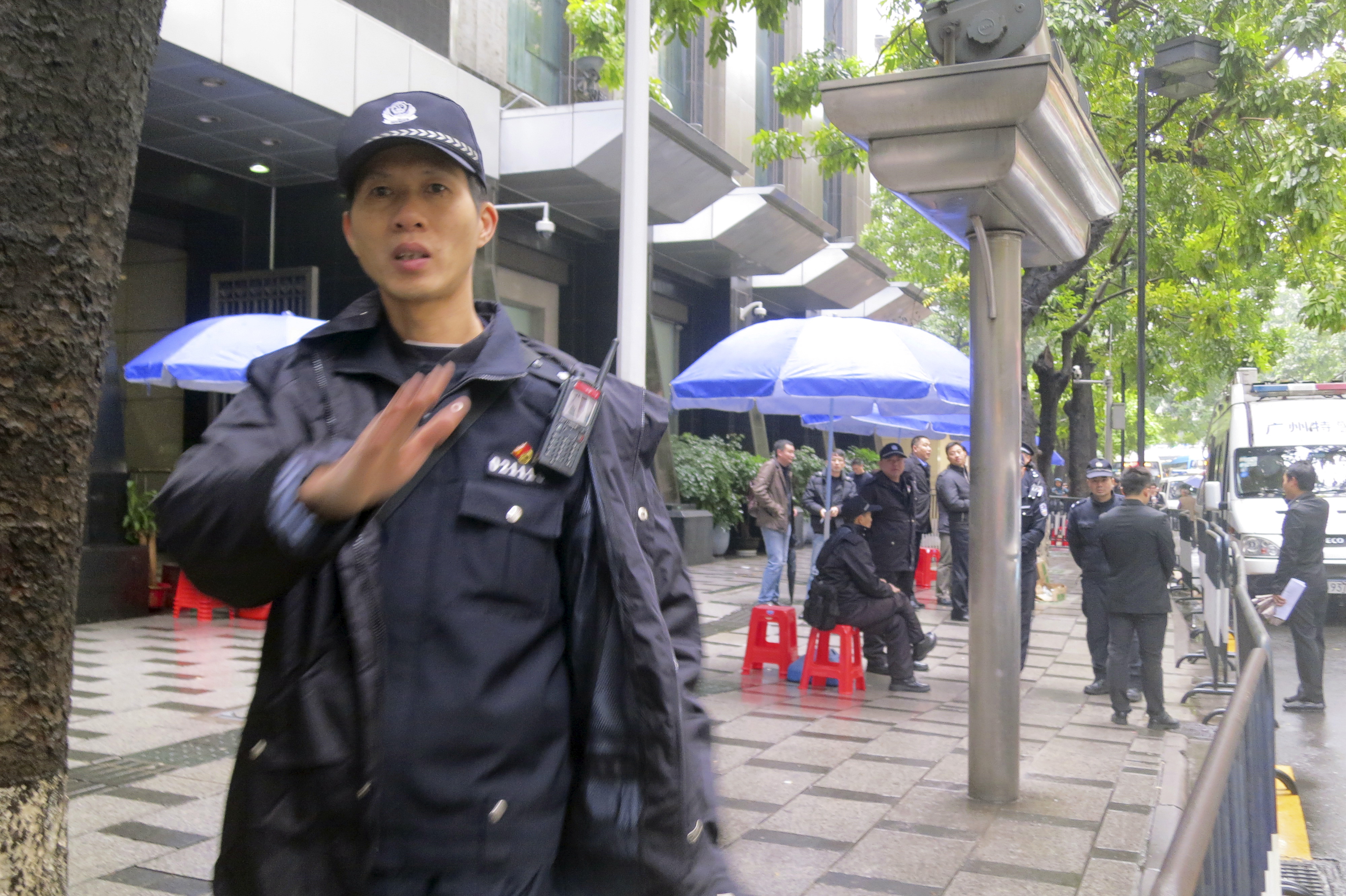 Policemen stand guard outside a court in the southern Chinese city of Guangzhou
