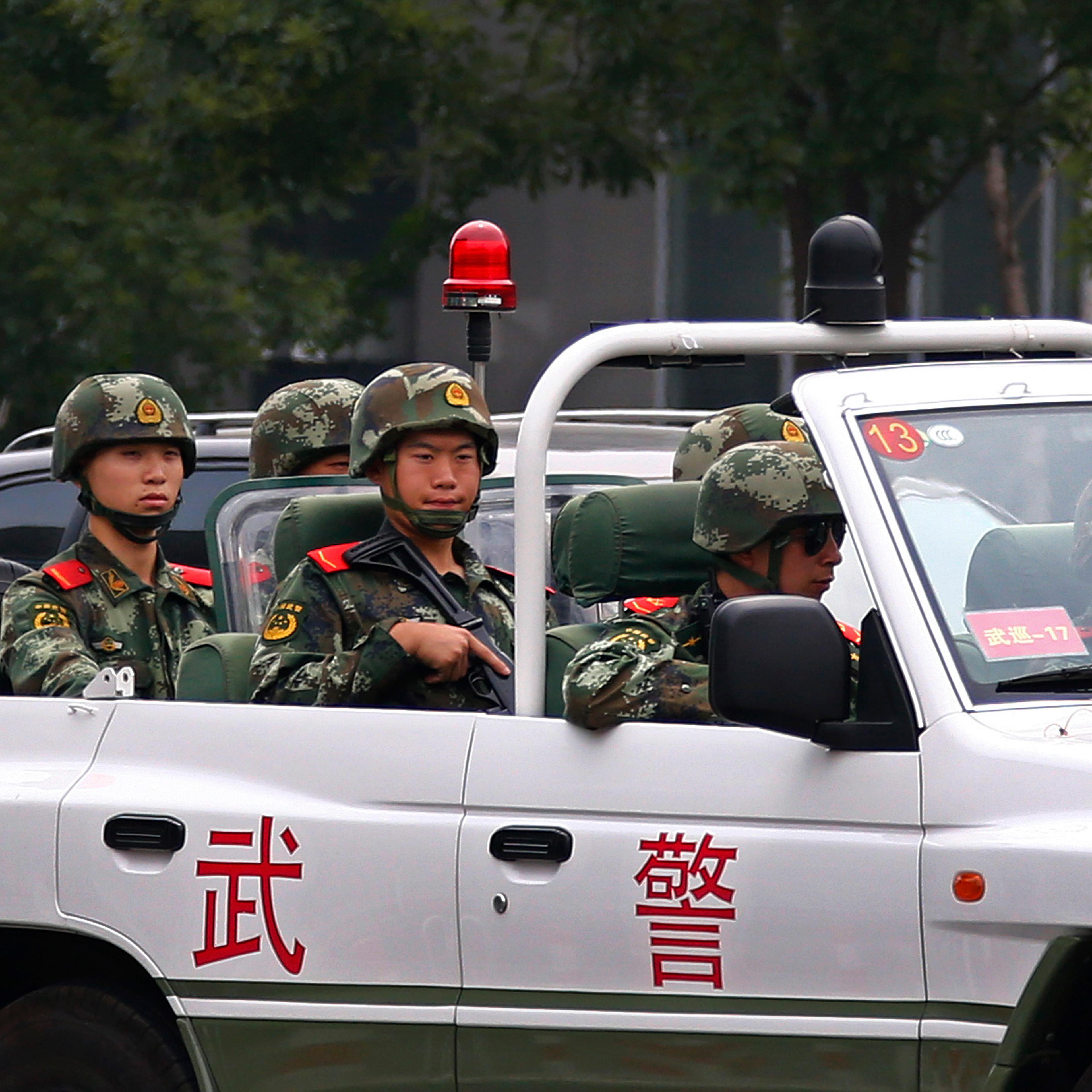 Paramilitary policemen patrol along Chang'an Avenue near Tiananmen Square in Beijing