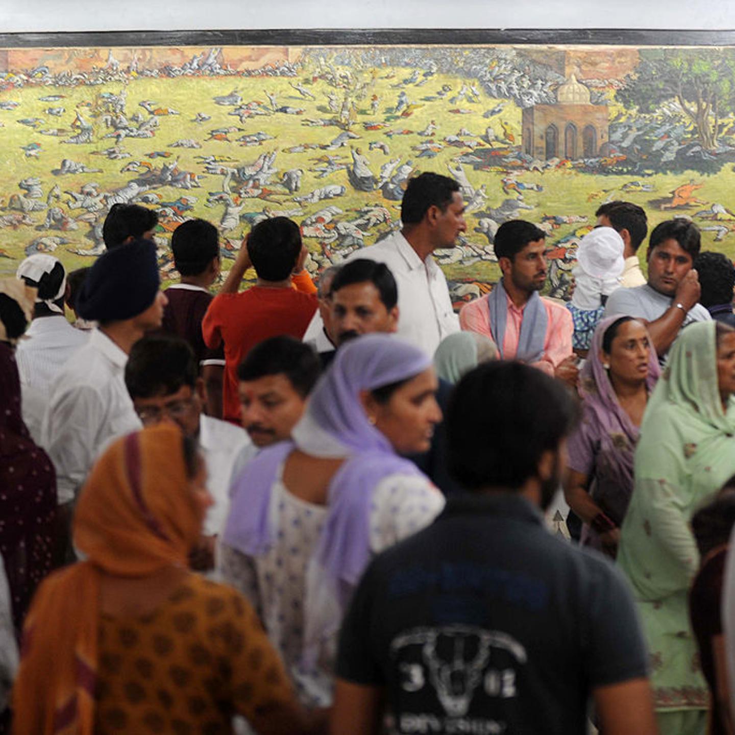 Indian visitors in Amritsar in 2011 look at a painting depicting the Jallianwala Bagh massacre