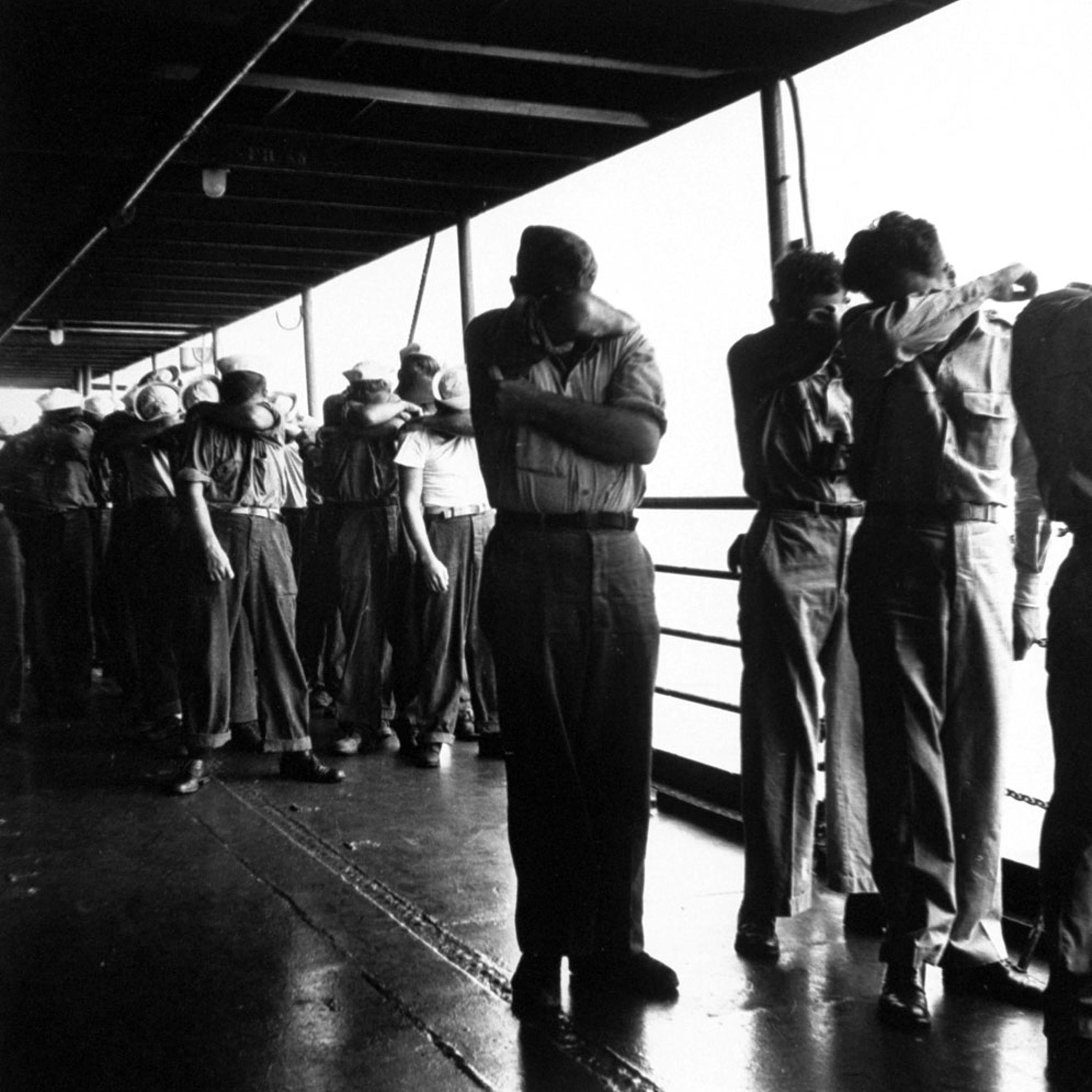 American sailors shield their eyes during a nuclear test at Bikini Atoll, July 1946.