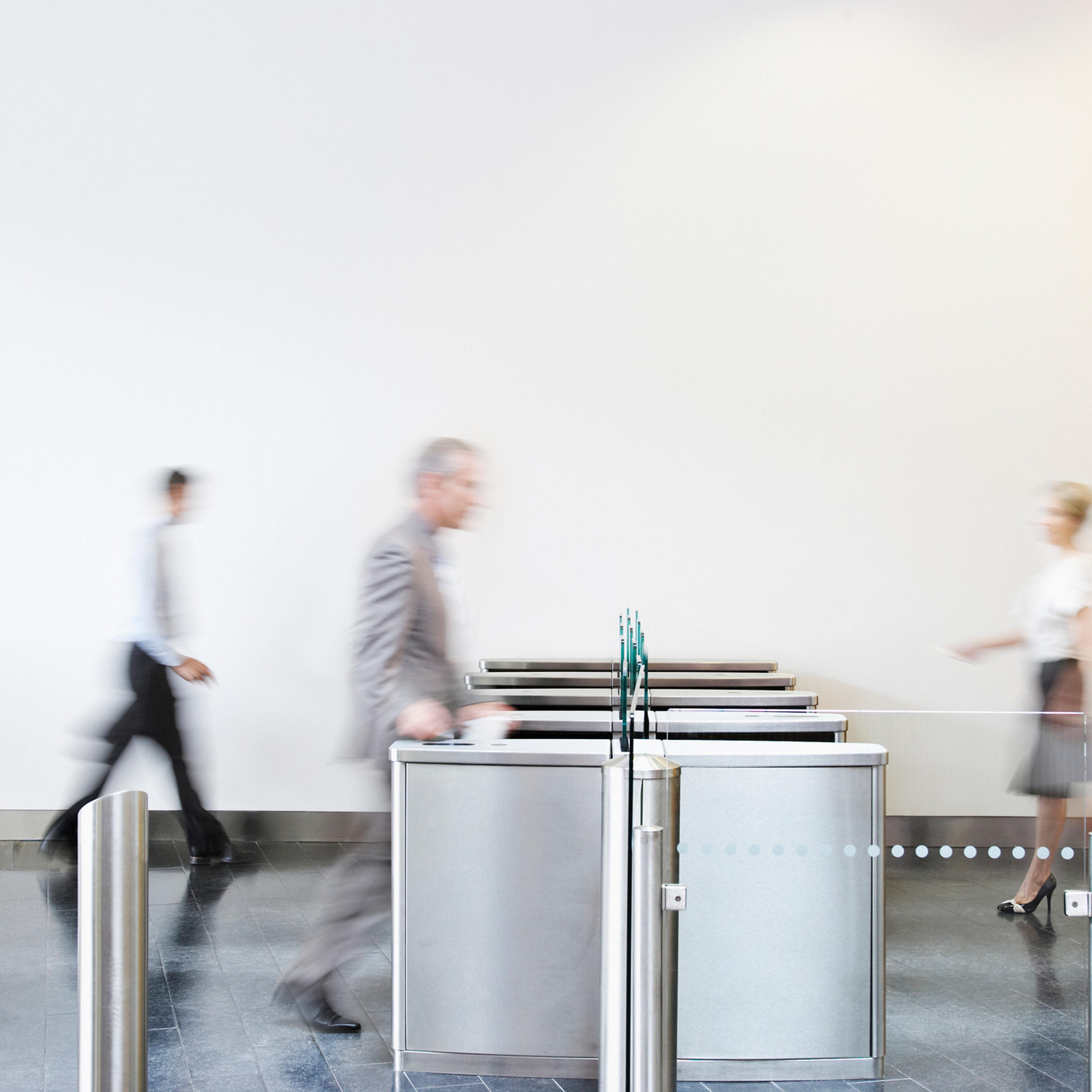 Businesspeople walking through turnstile