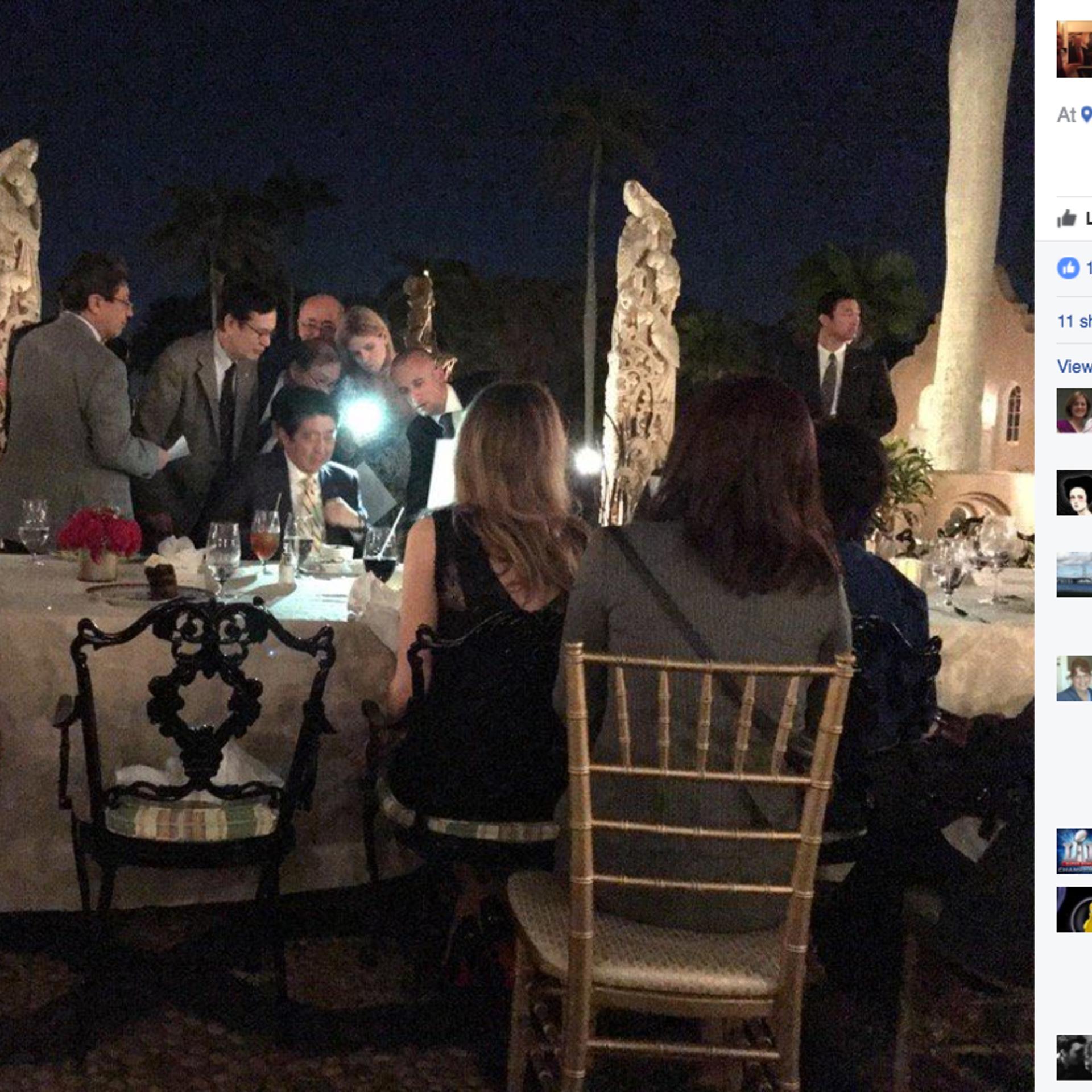 A screengrab of a photo posted on the Facebook page of Richard DeAgazio was said to show Japanese Prime Minister Shinzo Abe huddling with staffers during dinner at President Trump's Mar-a-Lago residence after news spread about North Korea's missile launc