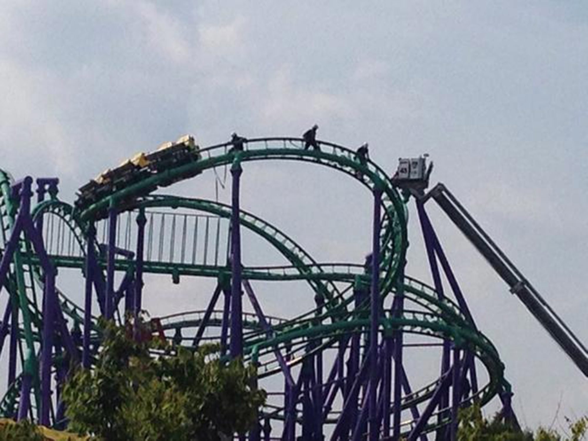 Firefighters rescuing 24 riders stuck atop the Joker's Jinx roller coaster at Six Flags theme park in Prince George's County, Maryland on August 10, 2014.