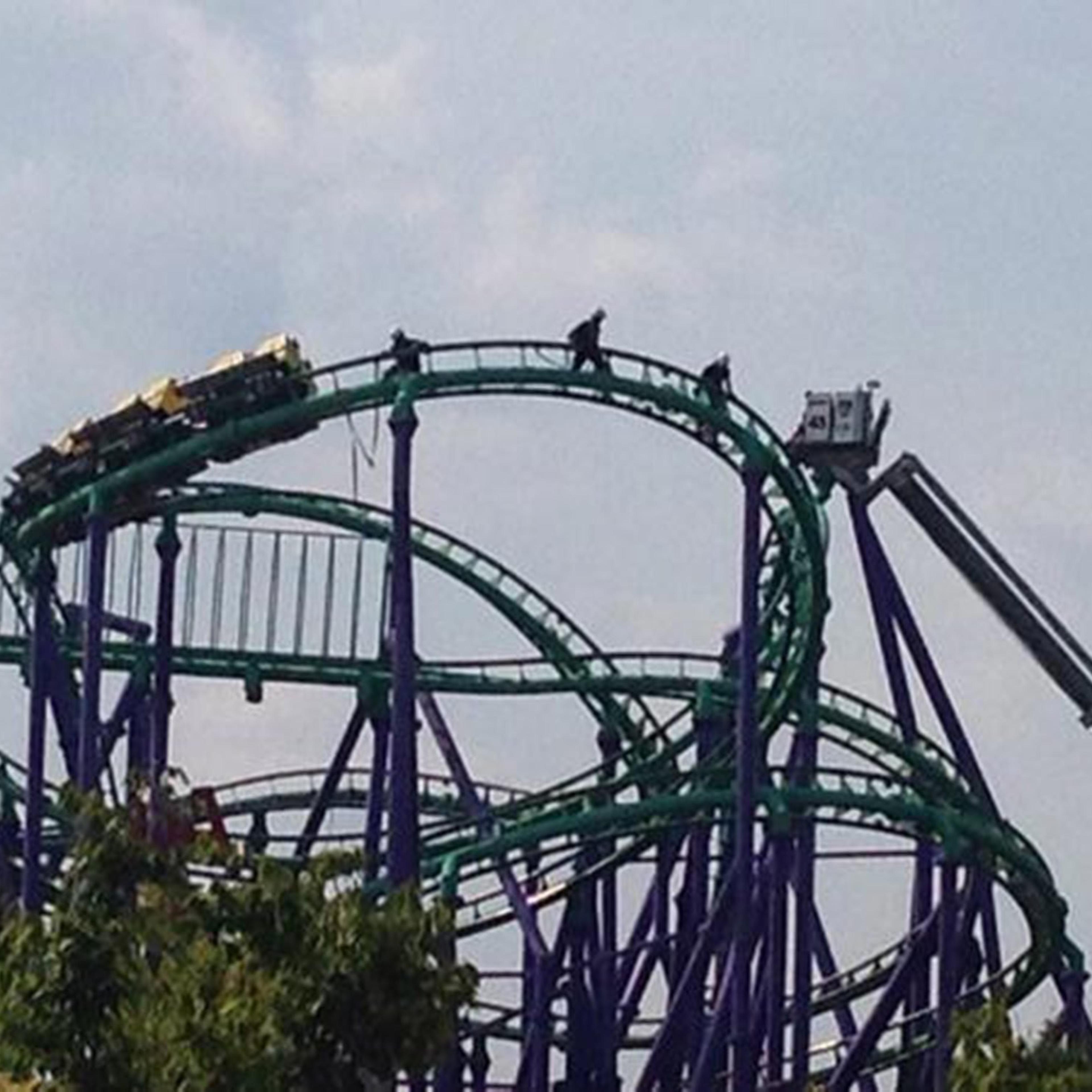Firefighters rescuing 24 riders stuck atop the Joker's Jinx roller coaster at Six Flags theme park in Prince George's County, Maryland on August 10, 2014.