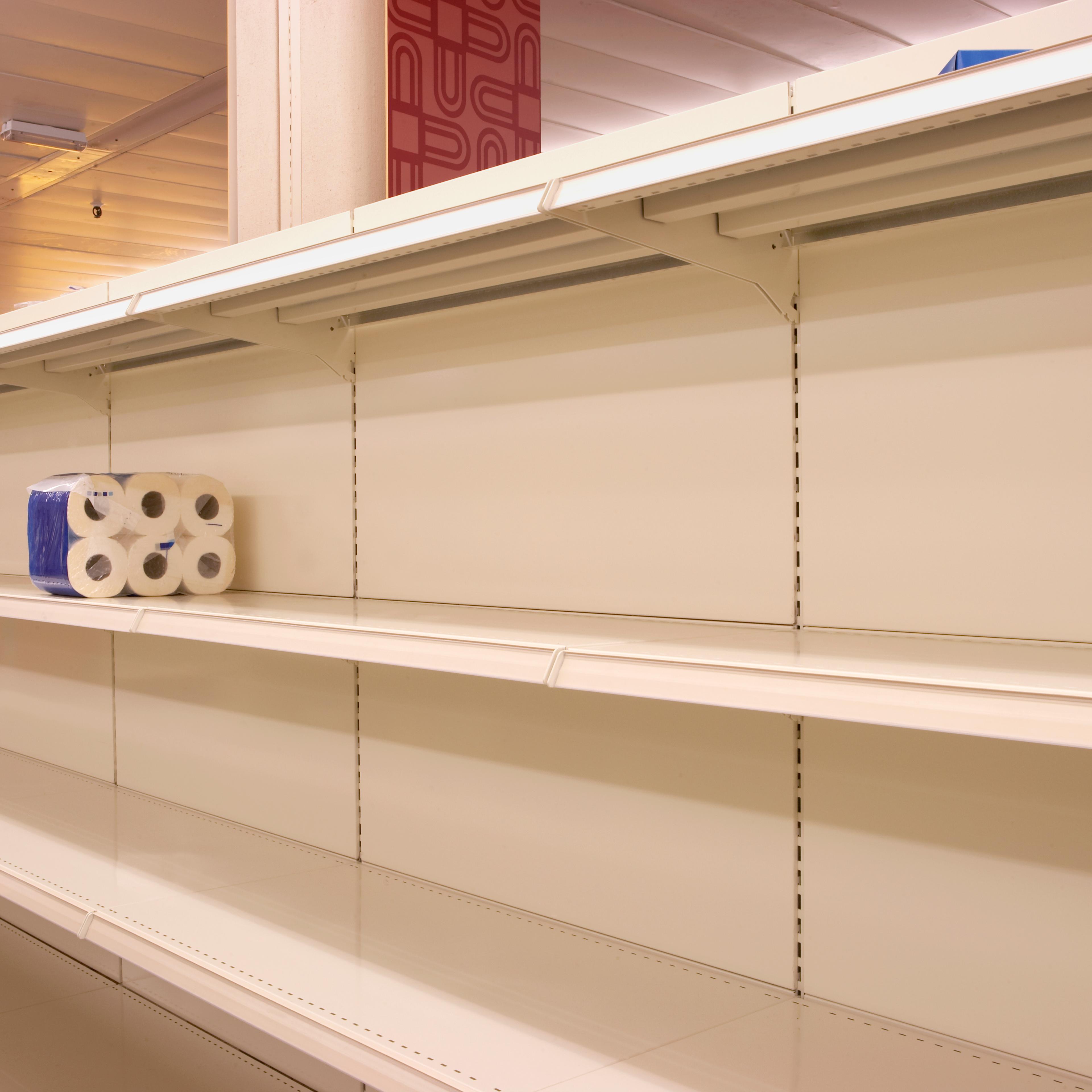 Toilet rolls on empty shop shelf